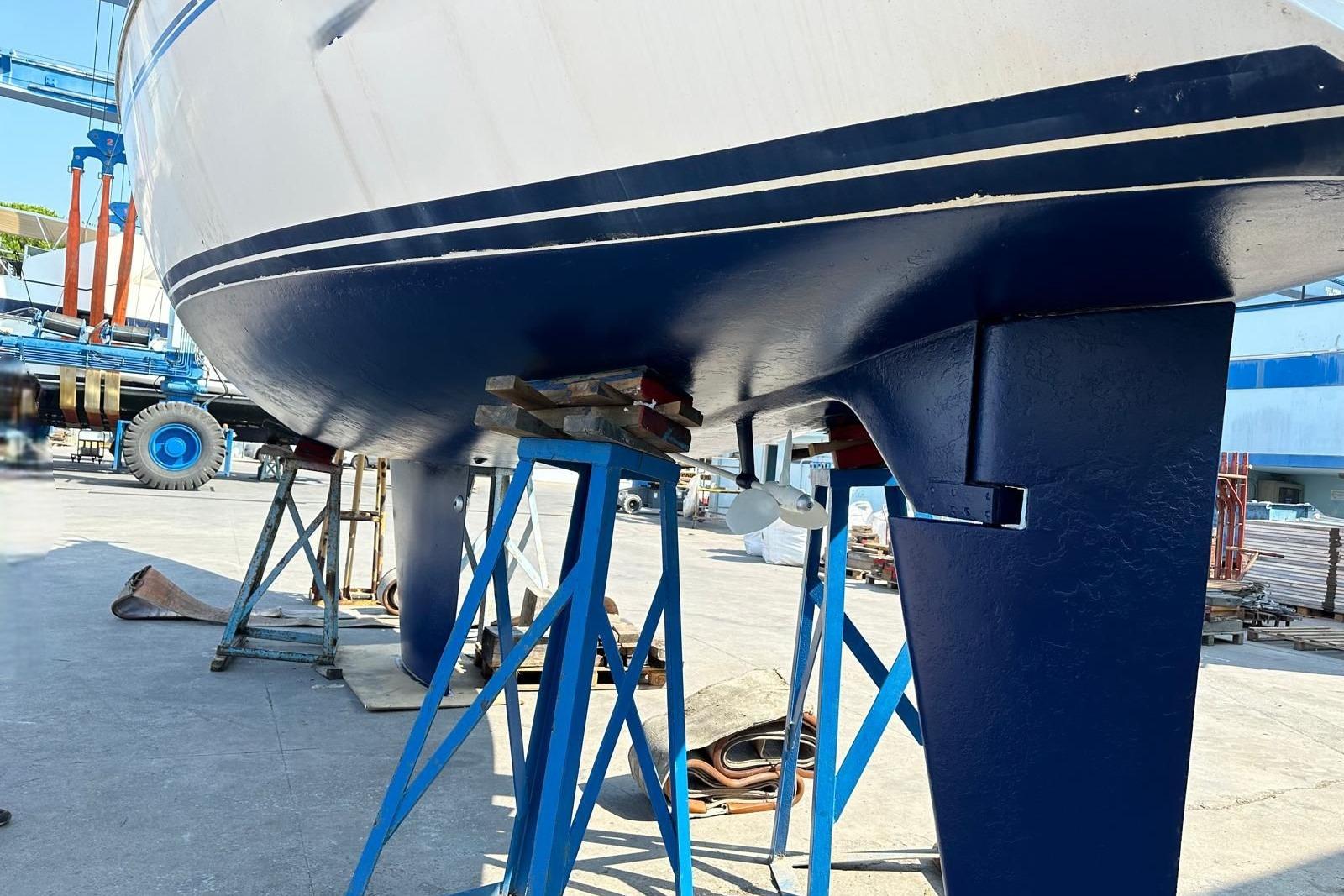 1990 Jeanneau Sun Shine 38 sailboat on stands in a shipyard.