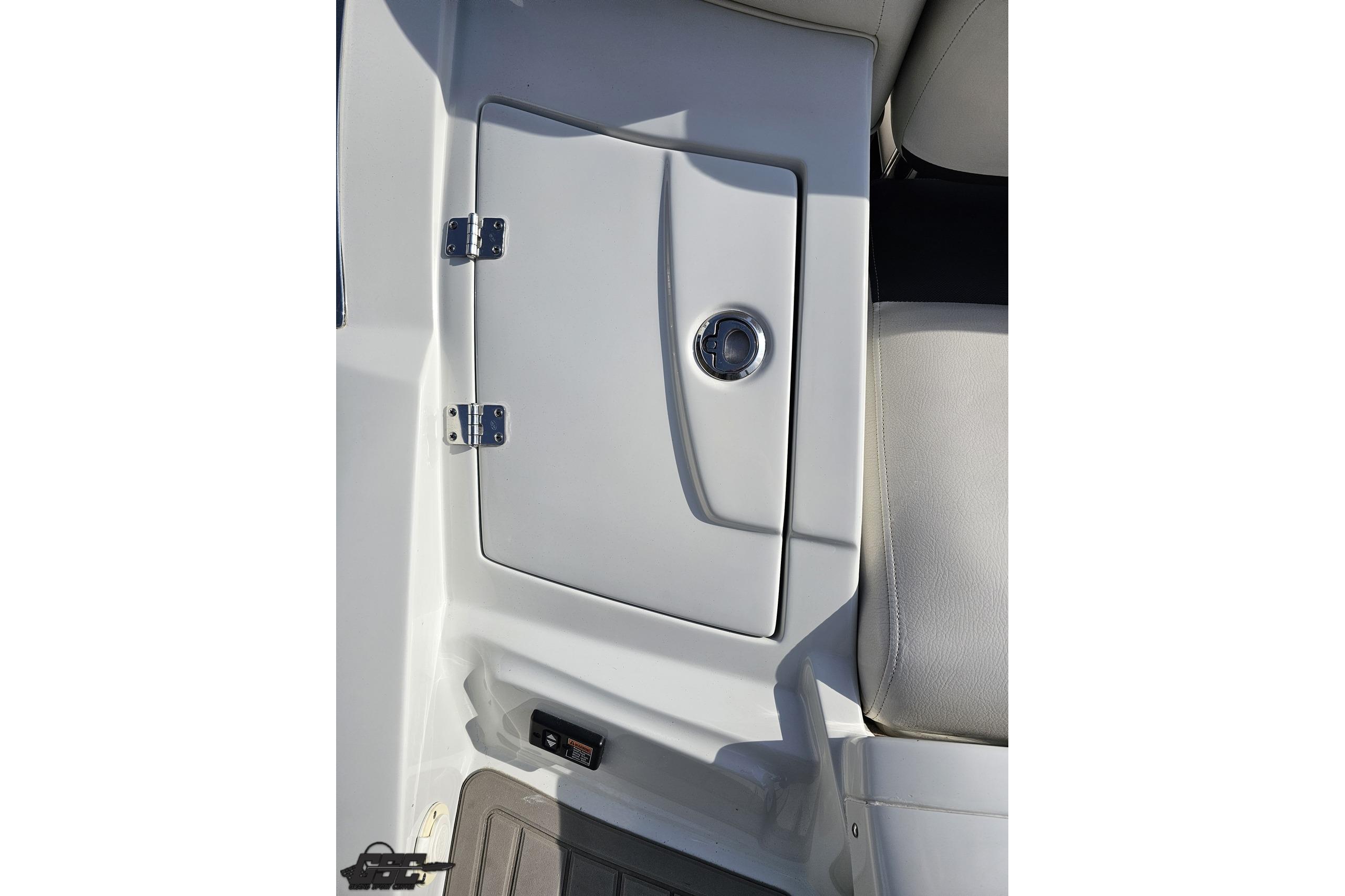 2019 Crownline 275 SS boat storage compartment with sleek design and chrome handle.