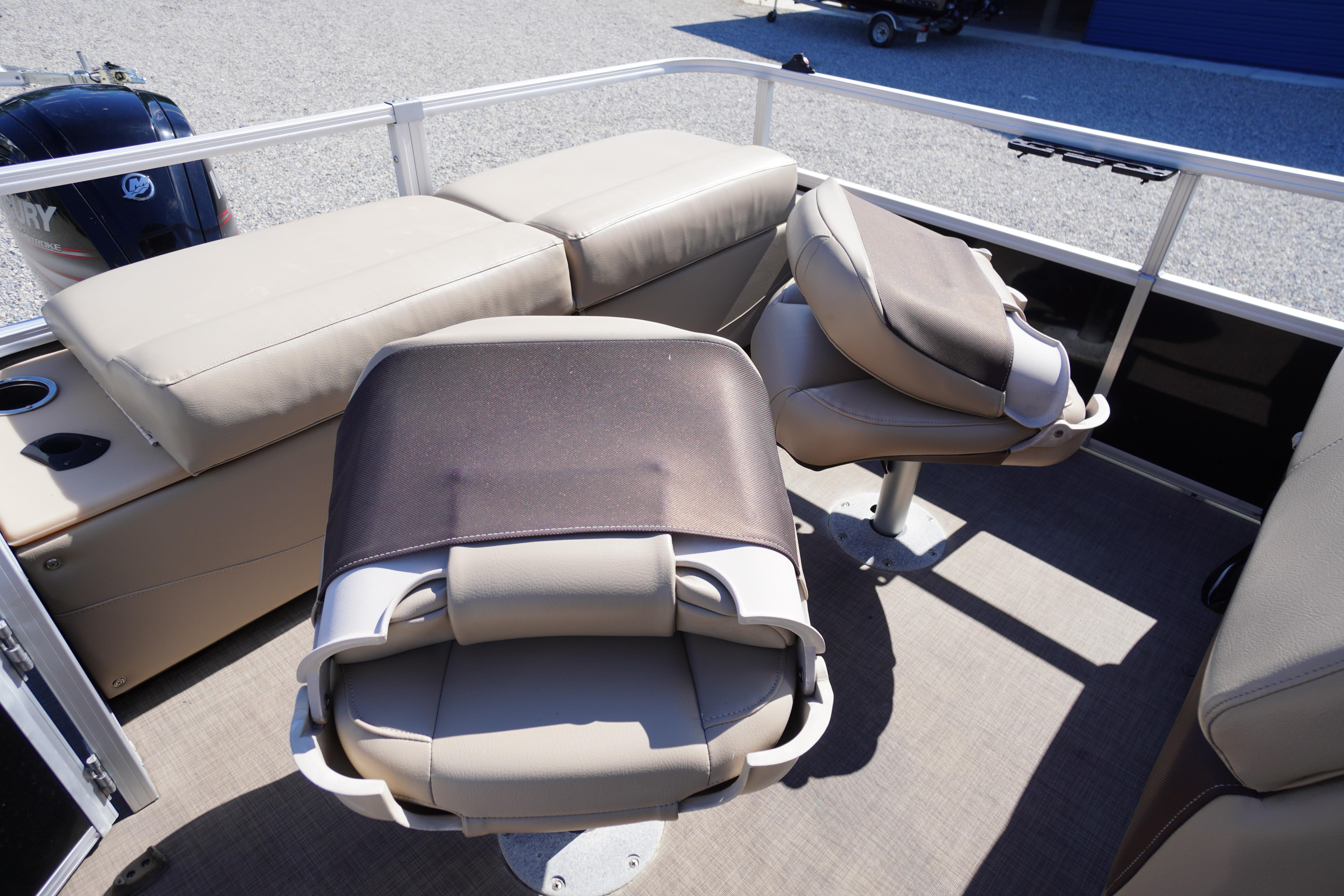 2019 SUNTRACKER Fishin' Barge 22 DLX interior with seating and boat motor.