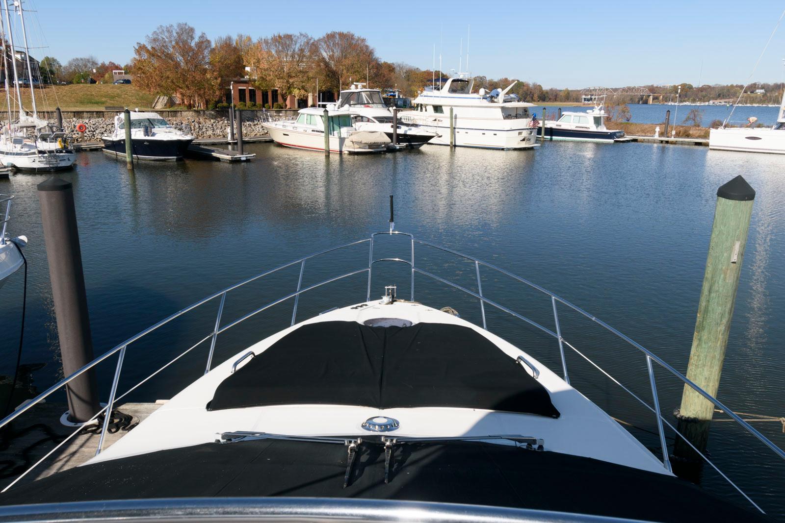 Azimut 50 Flybridge 2005 yacht docked in a serene marina setting.