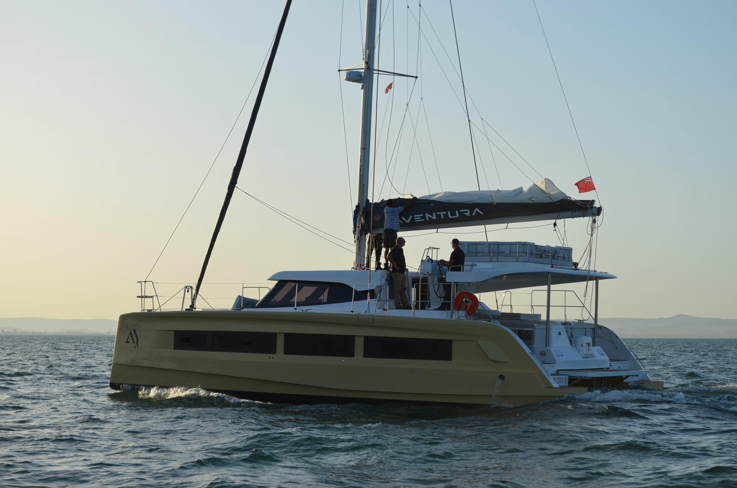 2026 Aventura 45 catamaran sailing on open water at sunset.