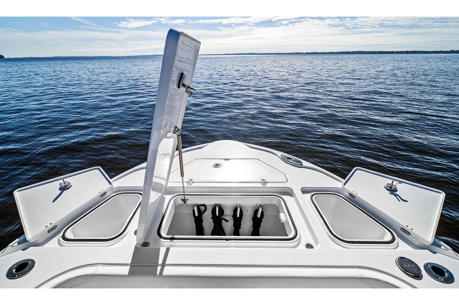 Manufacturer Provided Image: 2026 Blackfin 262 HB boat bow with open storage compartments on a calm lake.