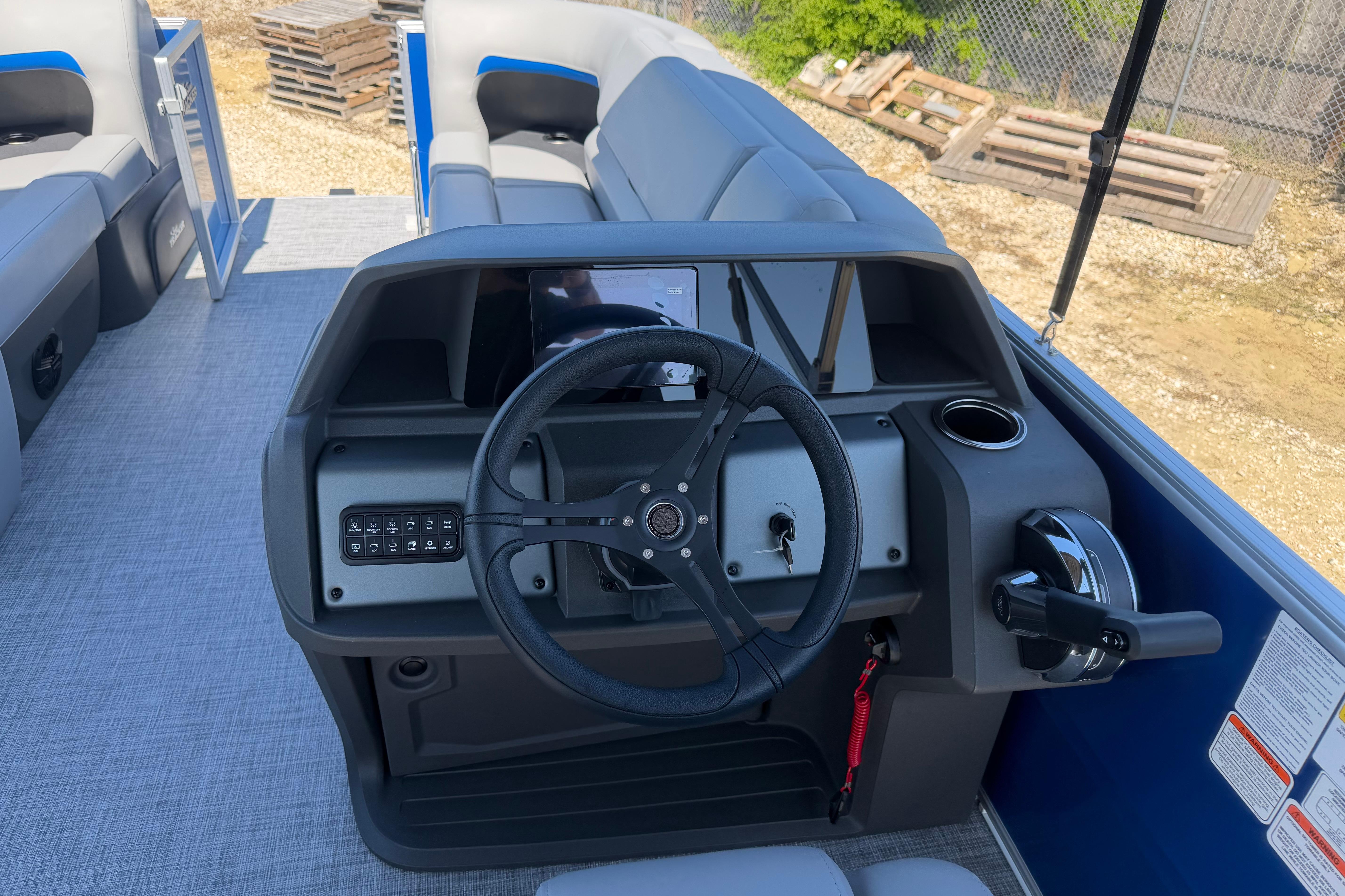 2026 Sun Tracker Party Barge 20 DLX steering console with modern controls and seating.