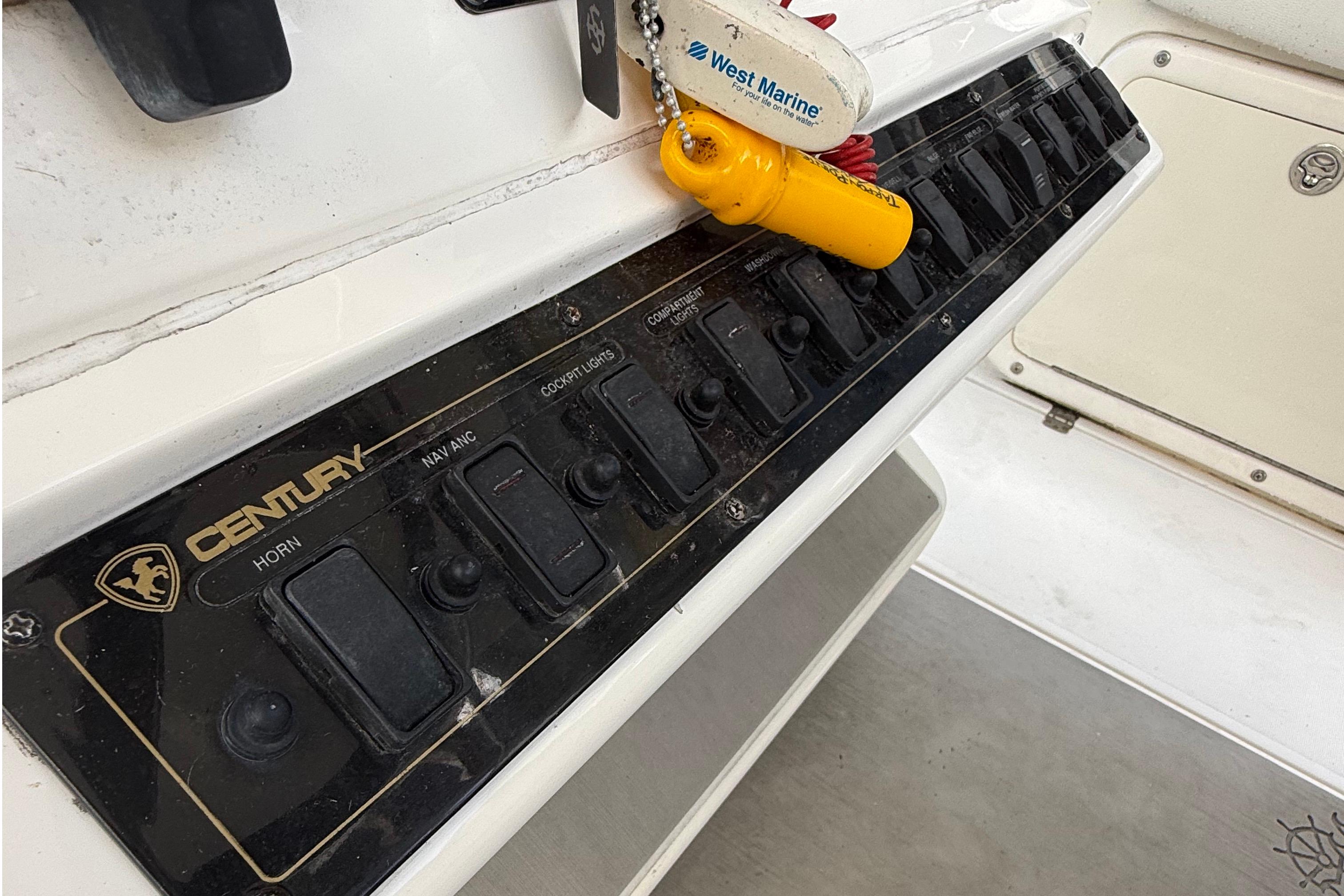 Century 2901 Center Console 2008 dashboard with control switches and West Marine keychain.