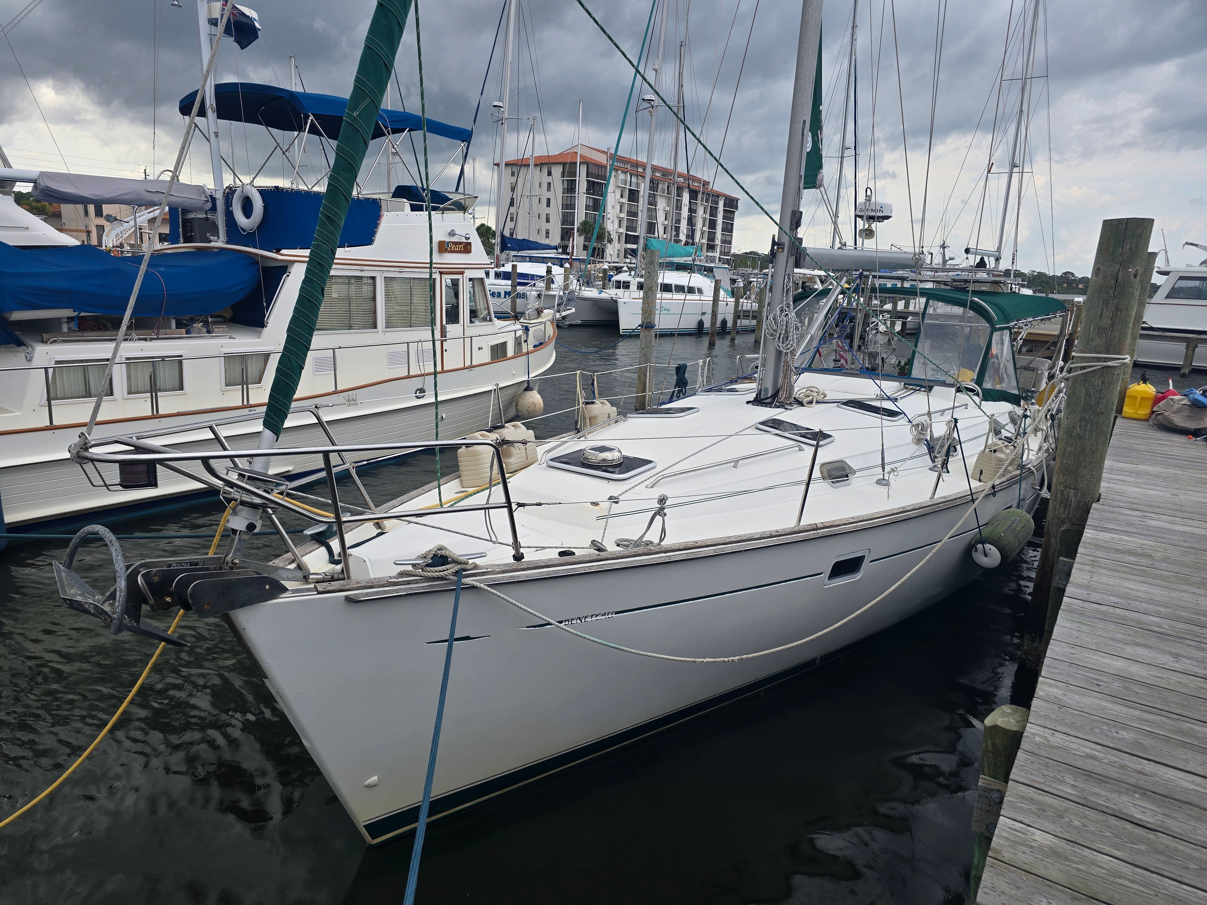 A 1998 Beneteau 411 sailboat docked in a busy marina.