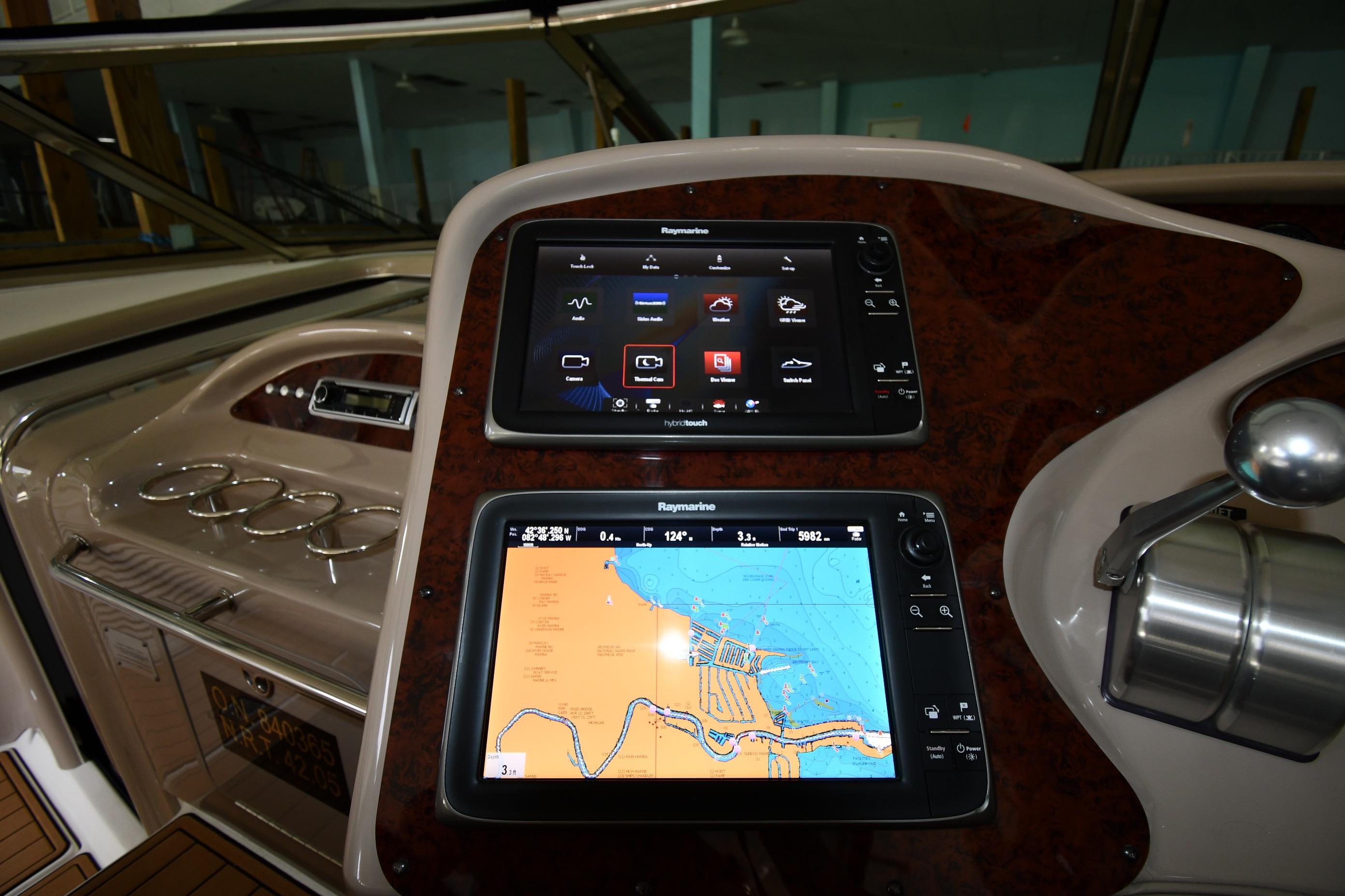 Helm of 2001 Sea Ray 540 Sundancer with navigation screens and controls.