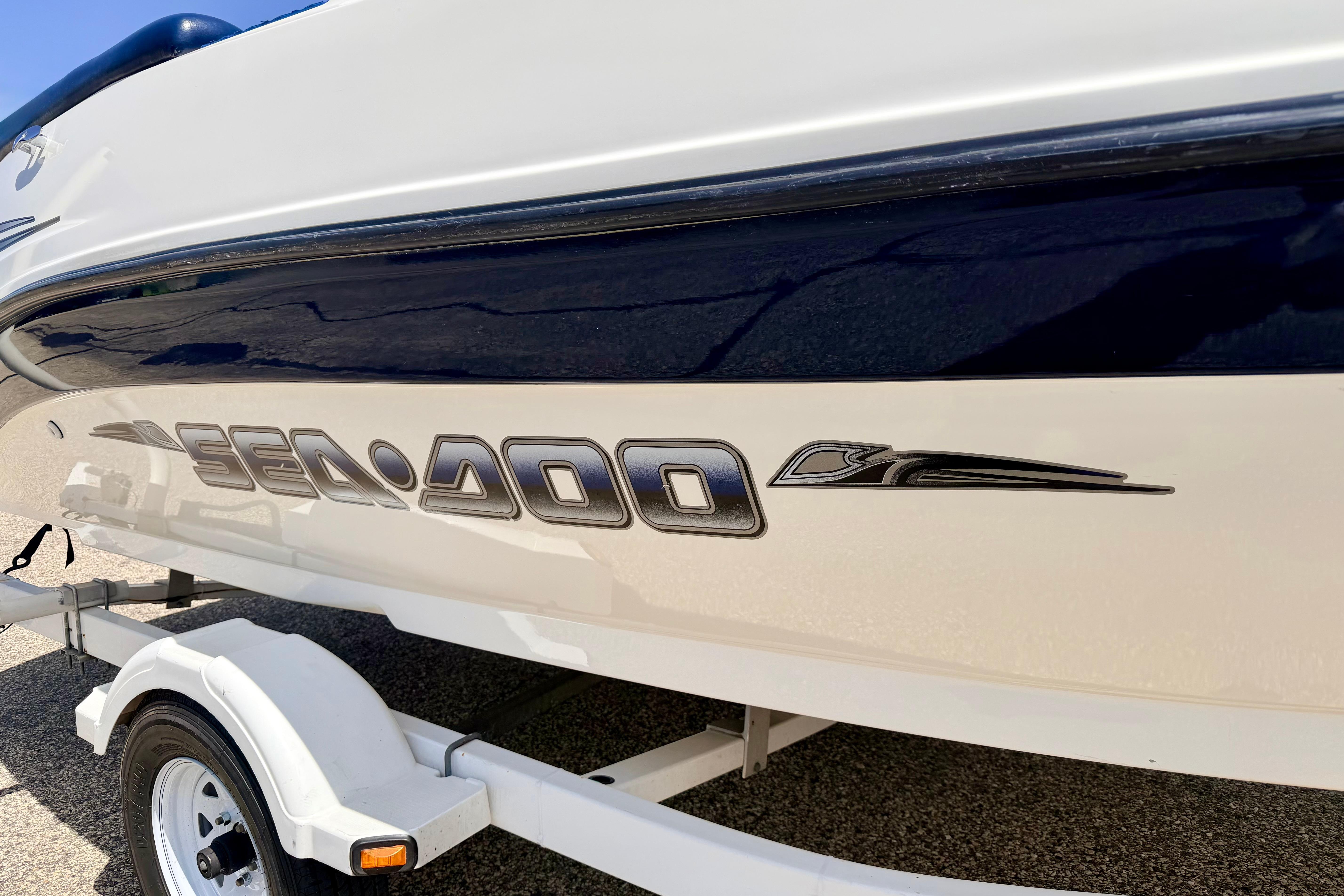 2004 Bombardier SEADOO Utopia 185 boat on trailer, side view.
