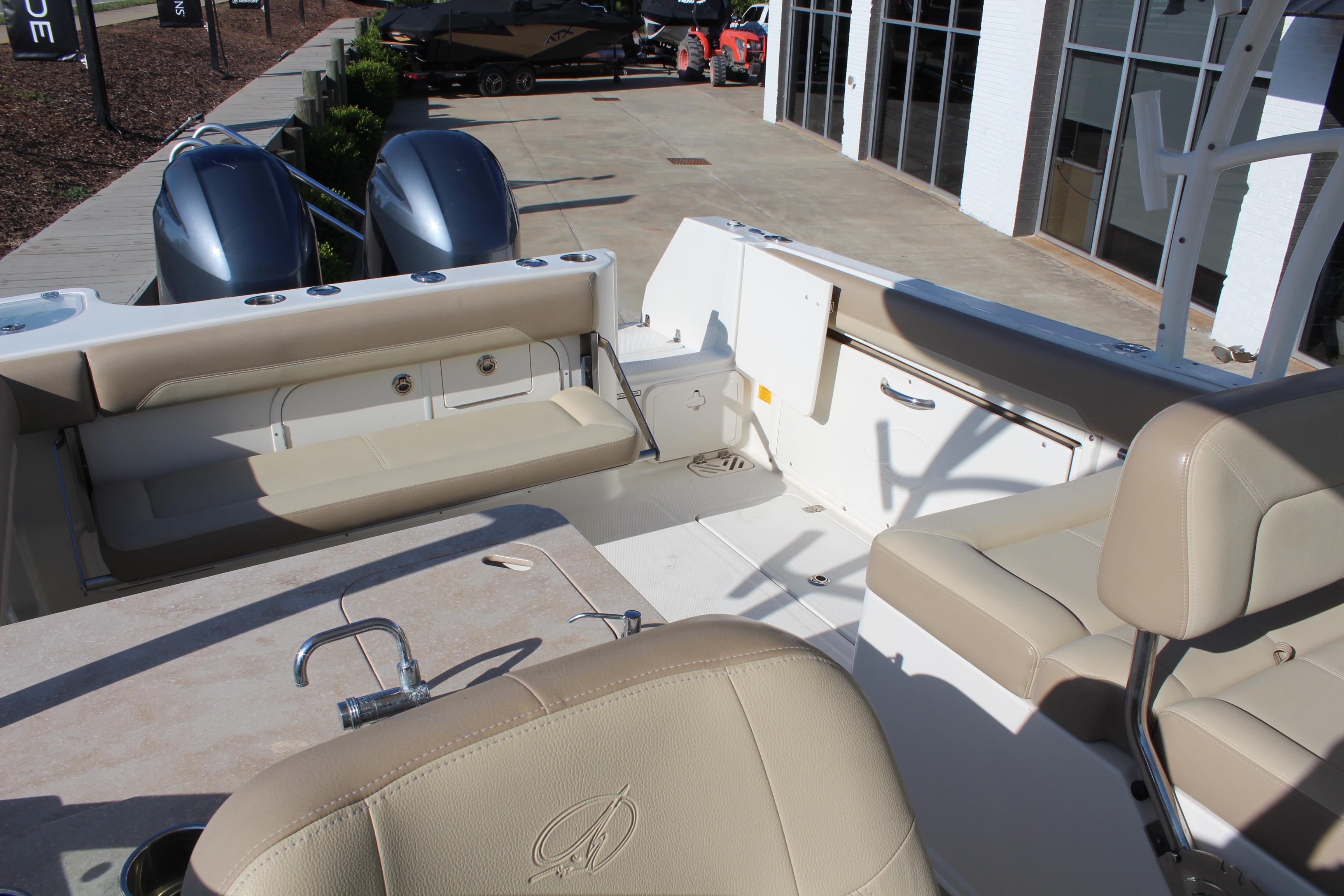 2017 Sailfish 275 DC boat interior with beige seating and dual outboard motors.