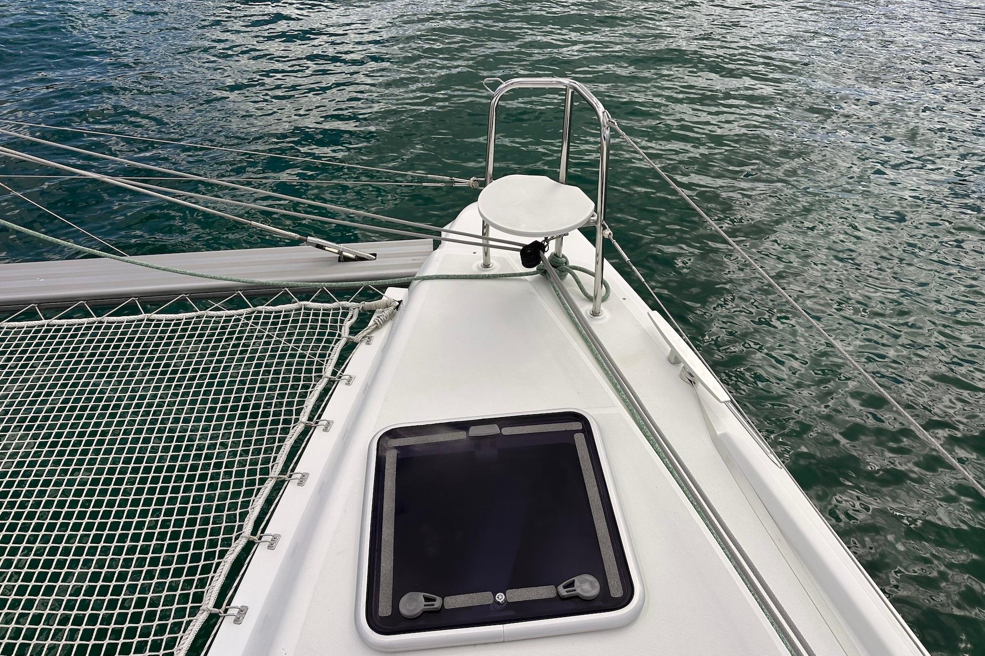 Bow of 2016 Lagoon 42 catamaran with netting and ocean view.