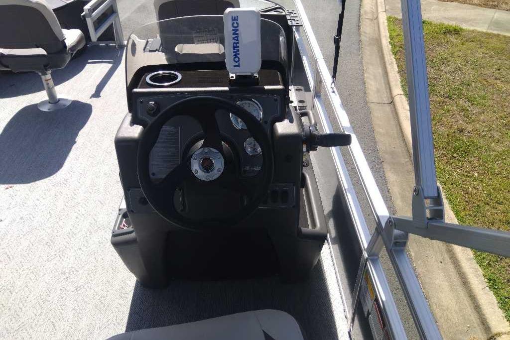 2026 Sun Tracker Bass Buggy 18 DLX boat console with steering wheel and Lowrance device.