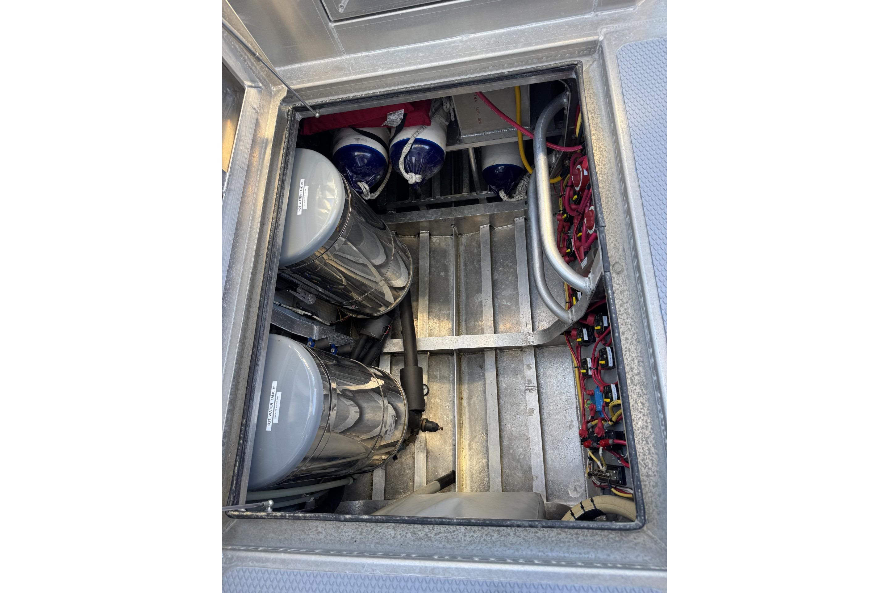 Engine compartment of a 2015 Armstrong Marine Power Cat, showcasing mechanical components and wiring.