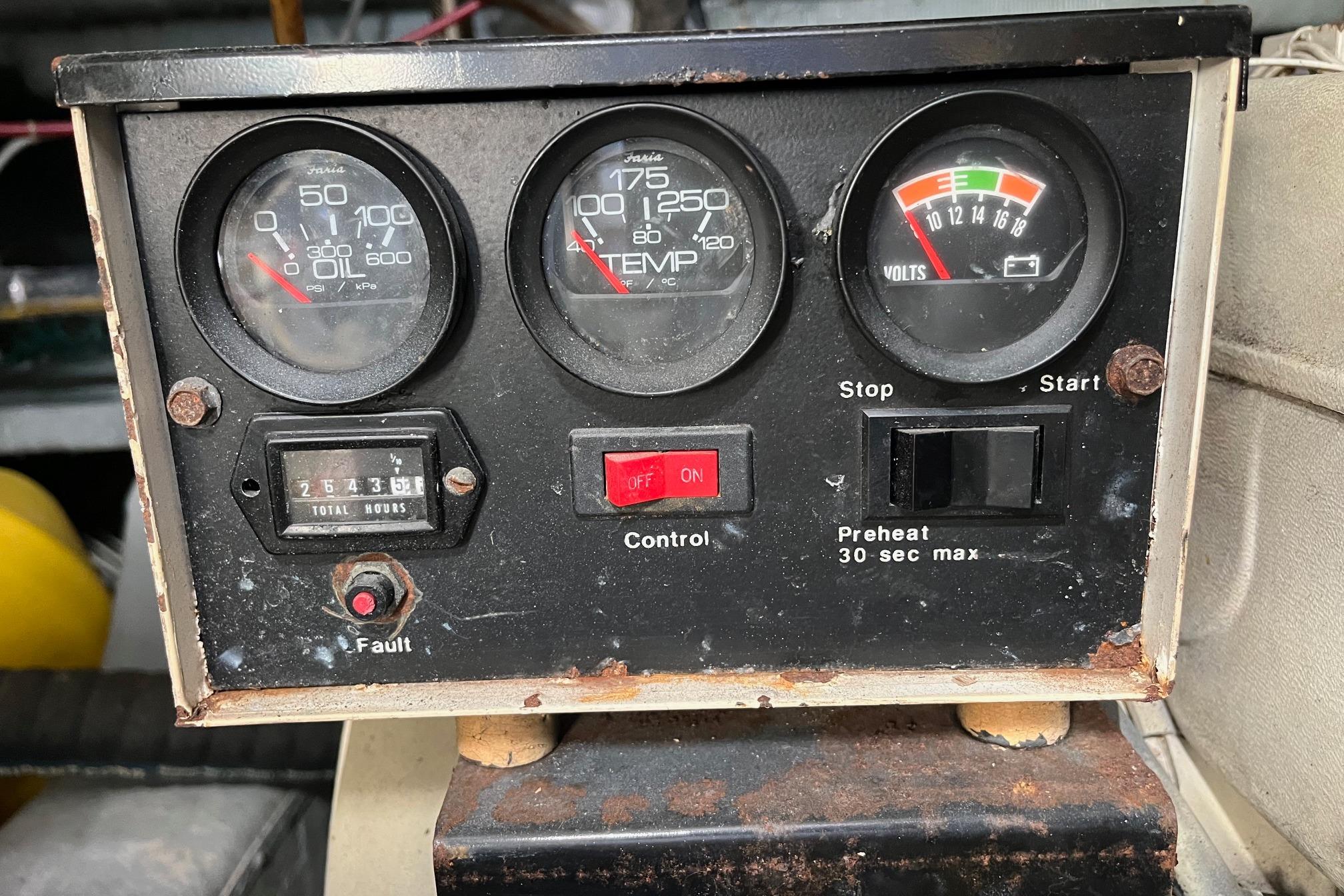 Control panel of a 1990 Mikelson 48 Sportfisher with gauges and switches.