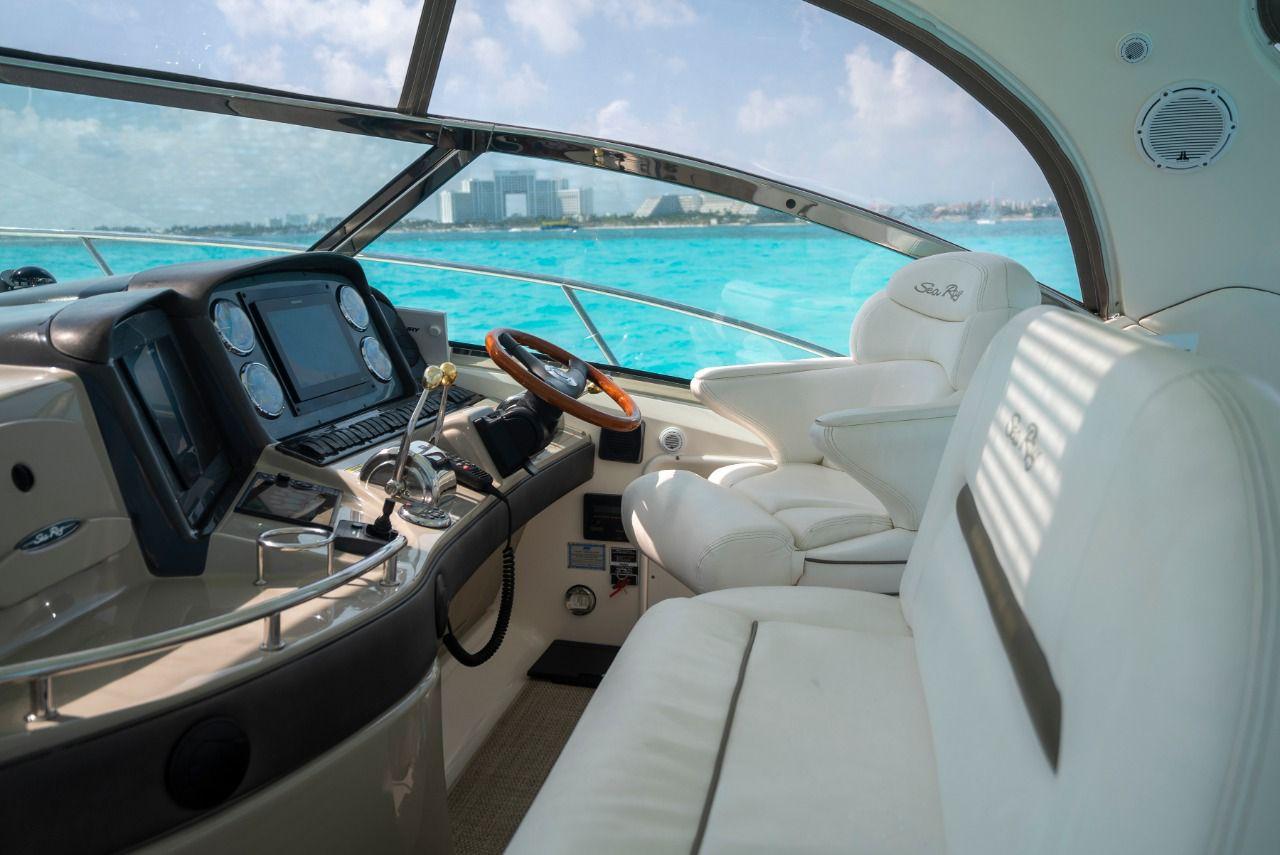 Interior view of 2006 Sea Ray 440 Sundancer yacht with luxurious seating and ocean backdrop.