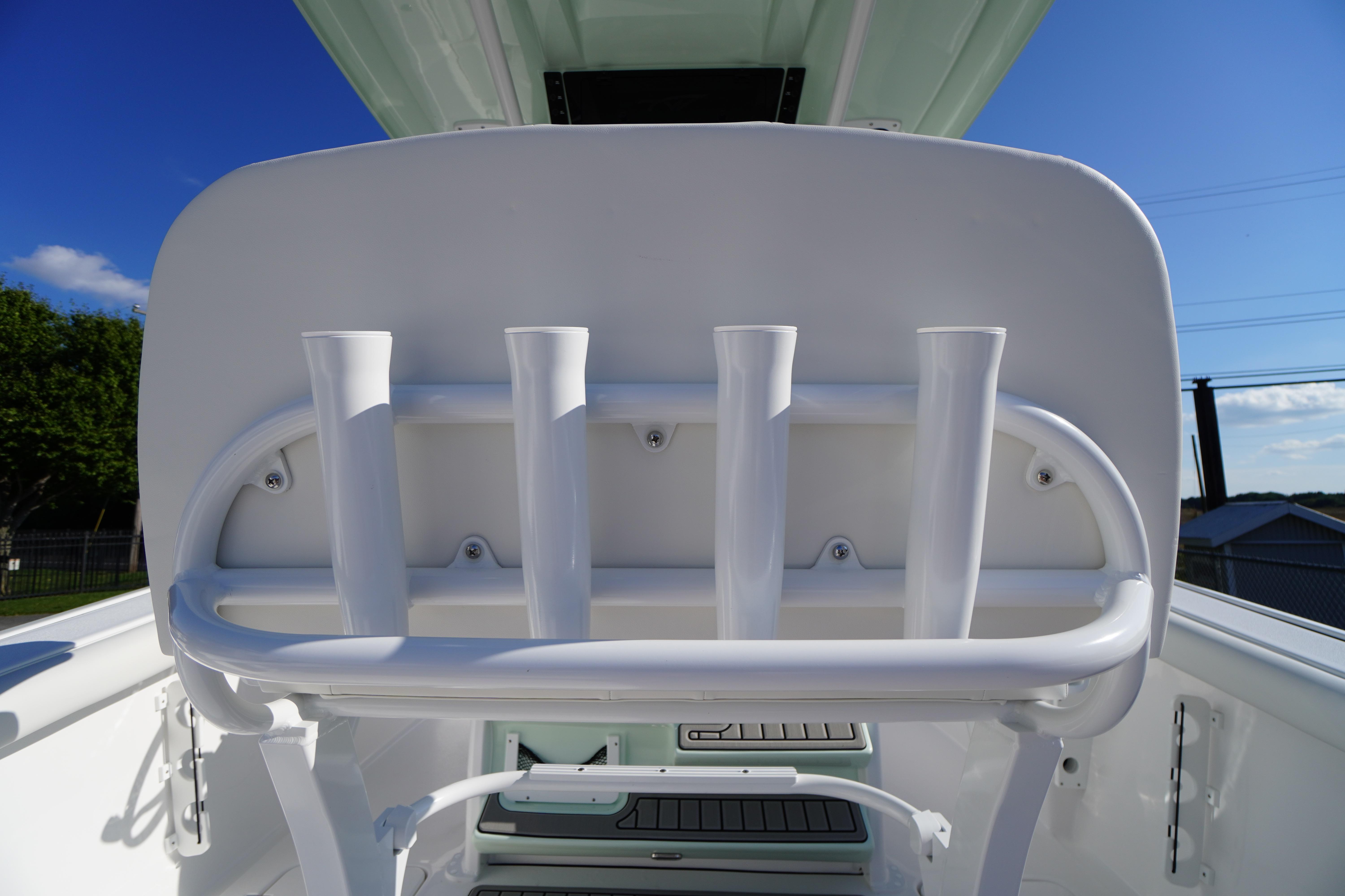 2026 Tidewater 272 LXF boat rod holders under clear blue sky.