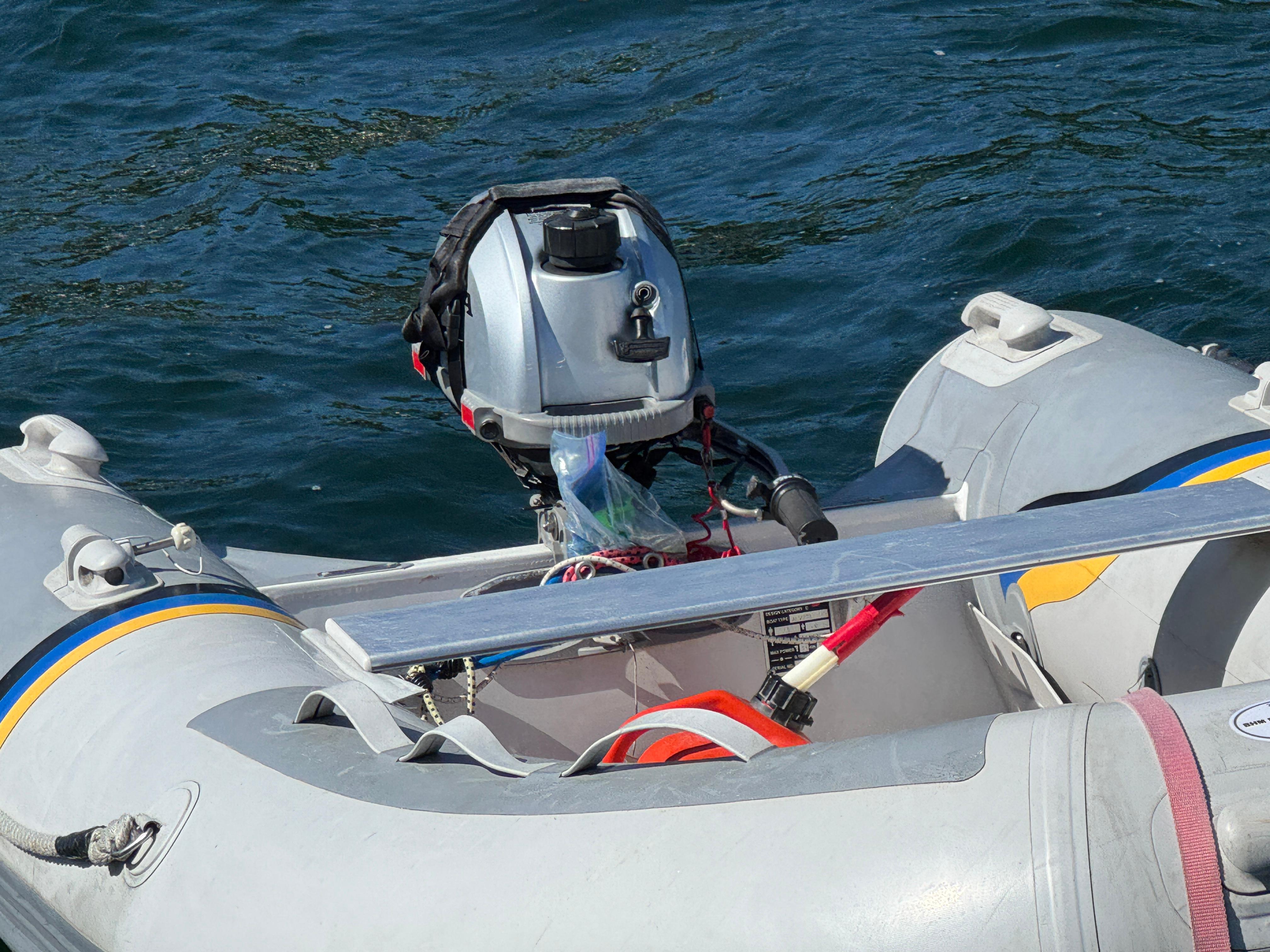 Inflatable boat with outboard motor on water, Nonsuch 30 Ultra, 1989 model.