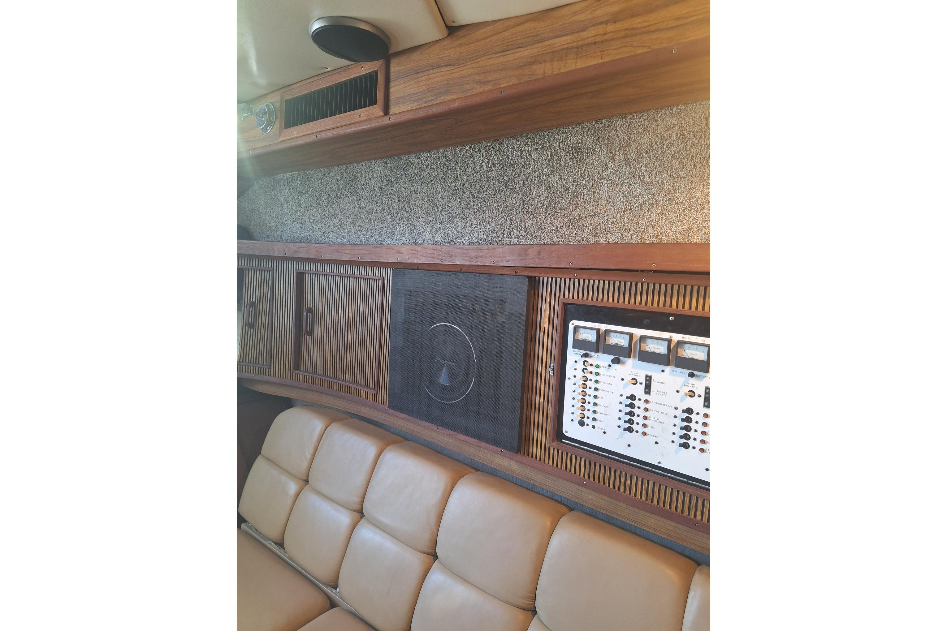 Interior of 1985 Sea Ray 390 Express Cruiser with control panel and leather seating.