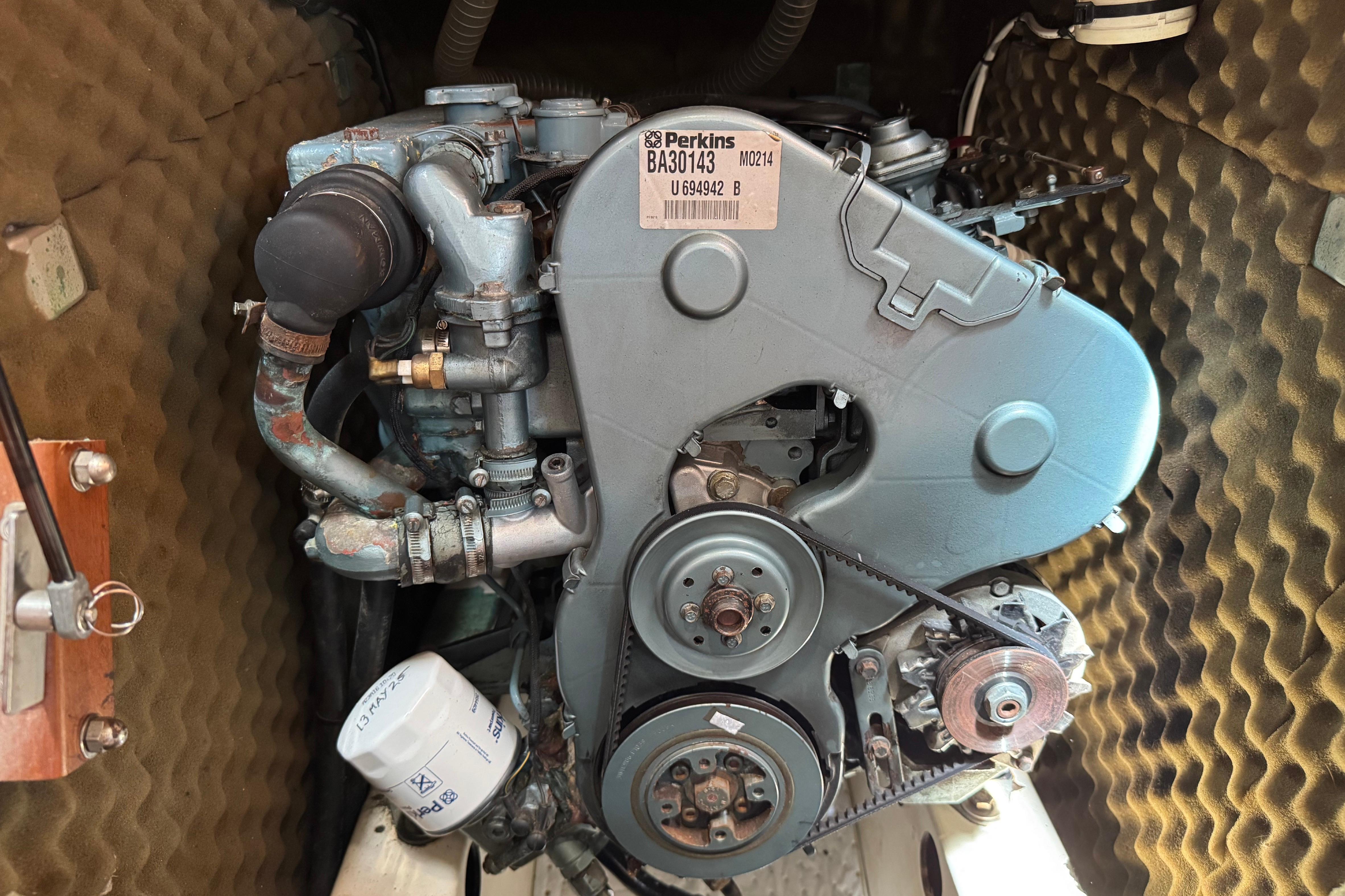 Perkins engine inside a 1997 Beneteau Oceanis 461 sailboat, showcasing mechanical components.