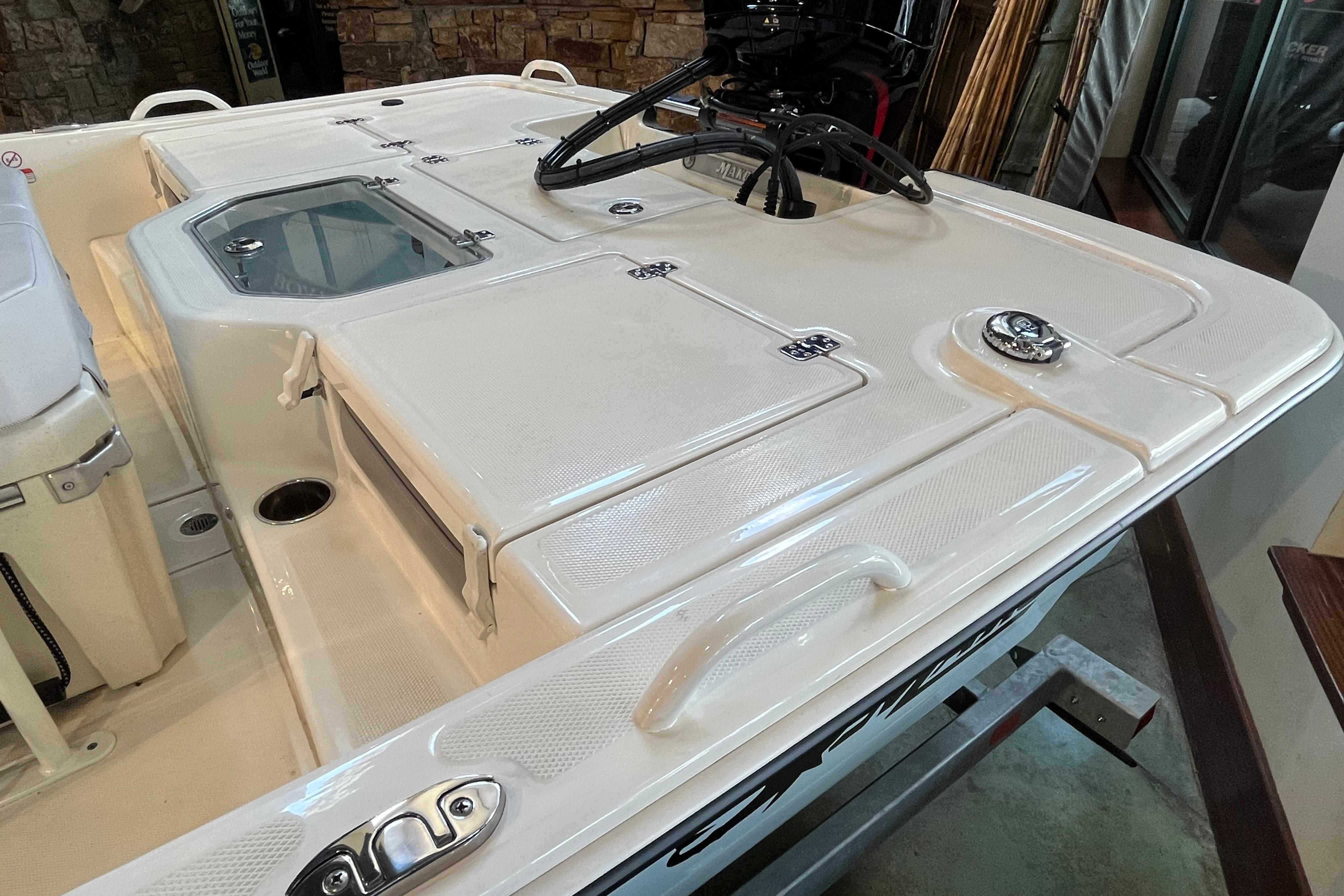 2024 Mako Pro Skiff 19 CC boat deck with storage compartments and seating.