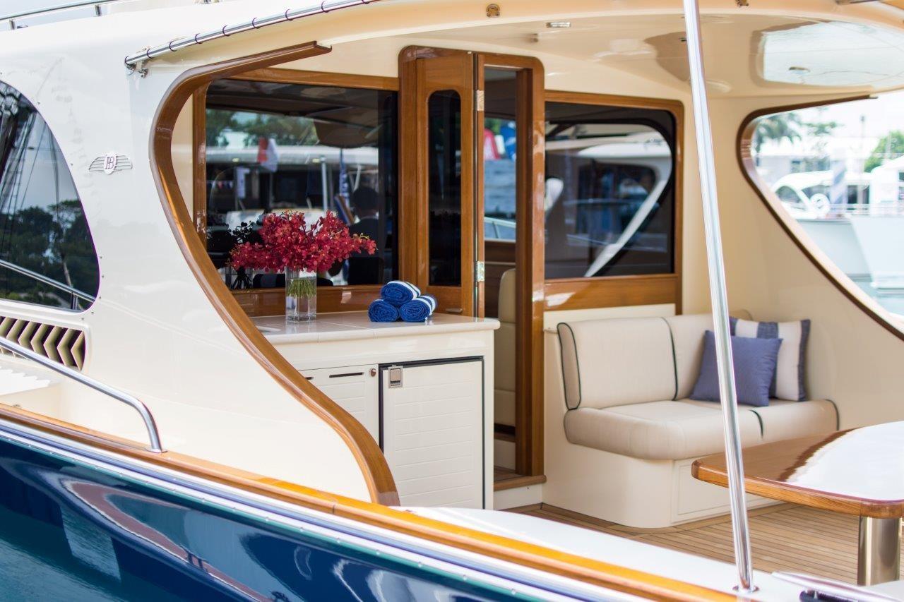 2026 Palm Beach Motor Yachts PB52 interior with elegant seating and floral arrangement.