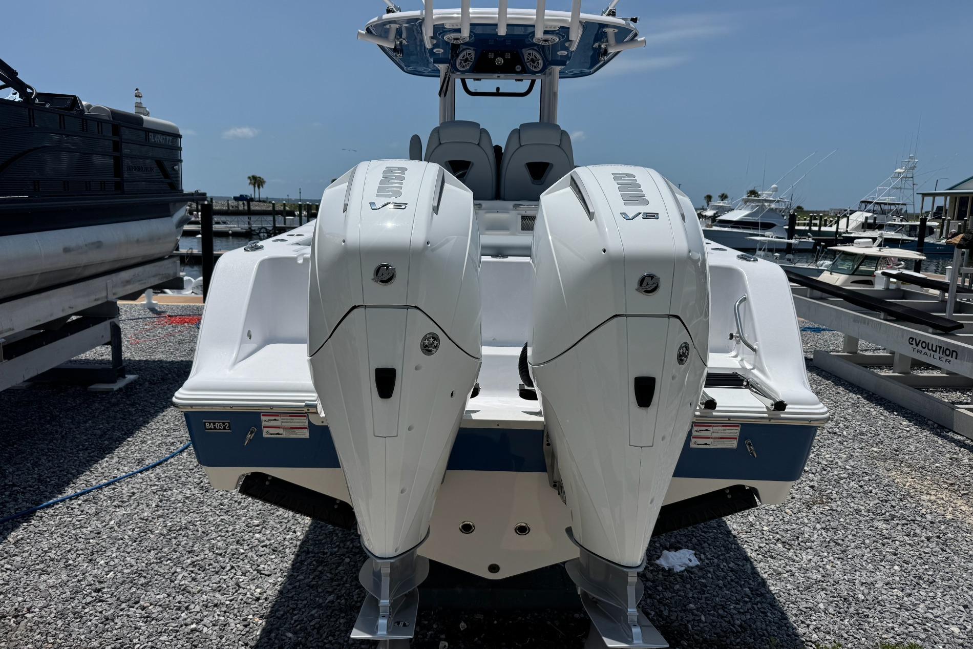 2026 Sportsman Open 262 Center Console with dual V6 engines at a marina.