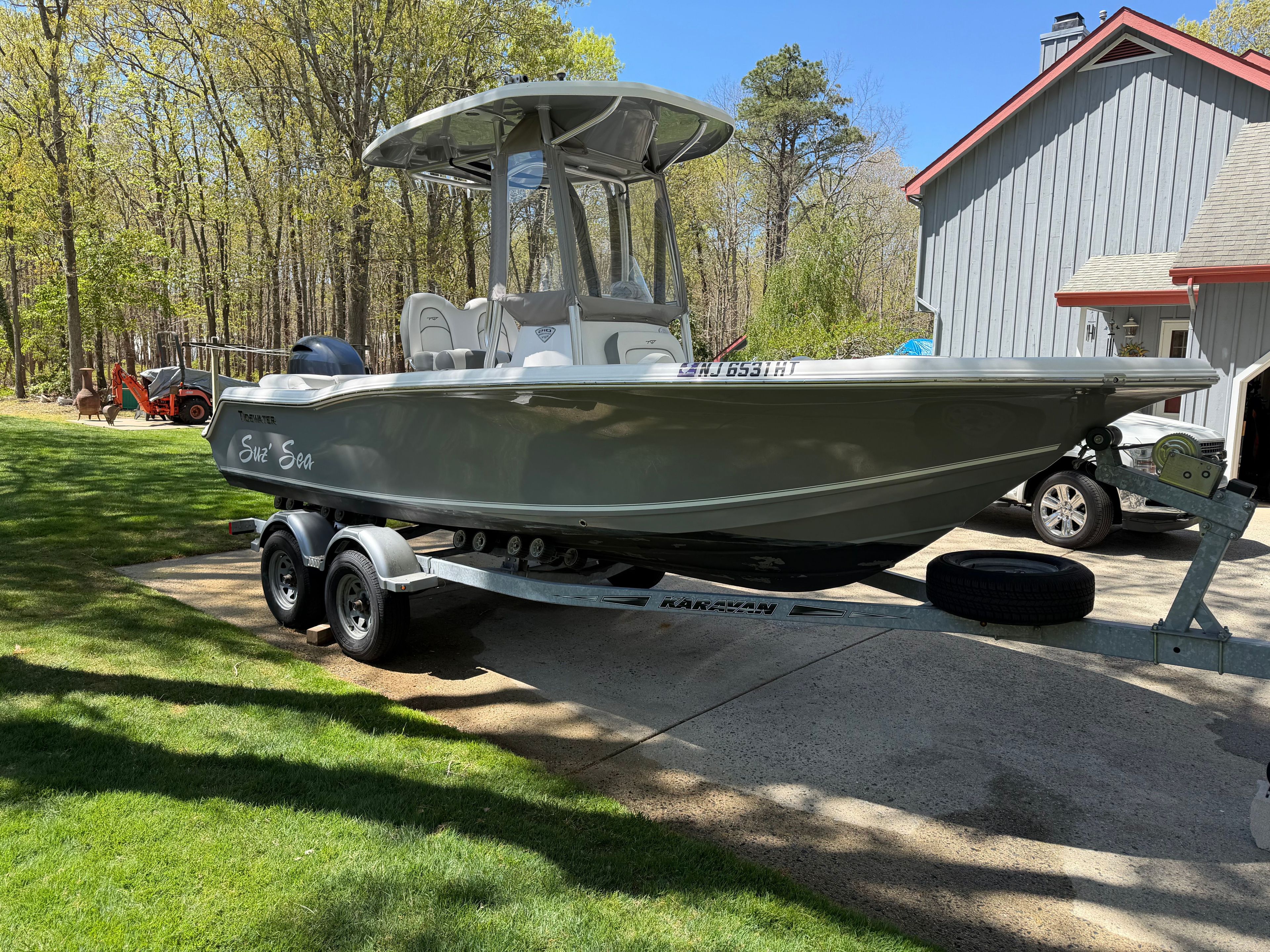 2016 Tidewater 210 LXF boat on trailer in yard.