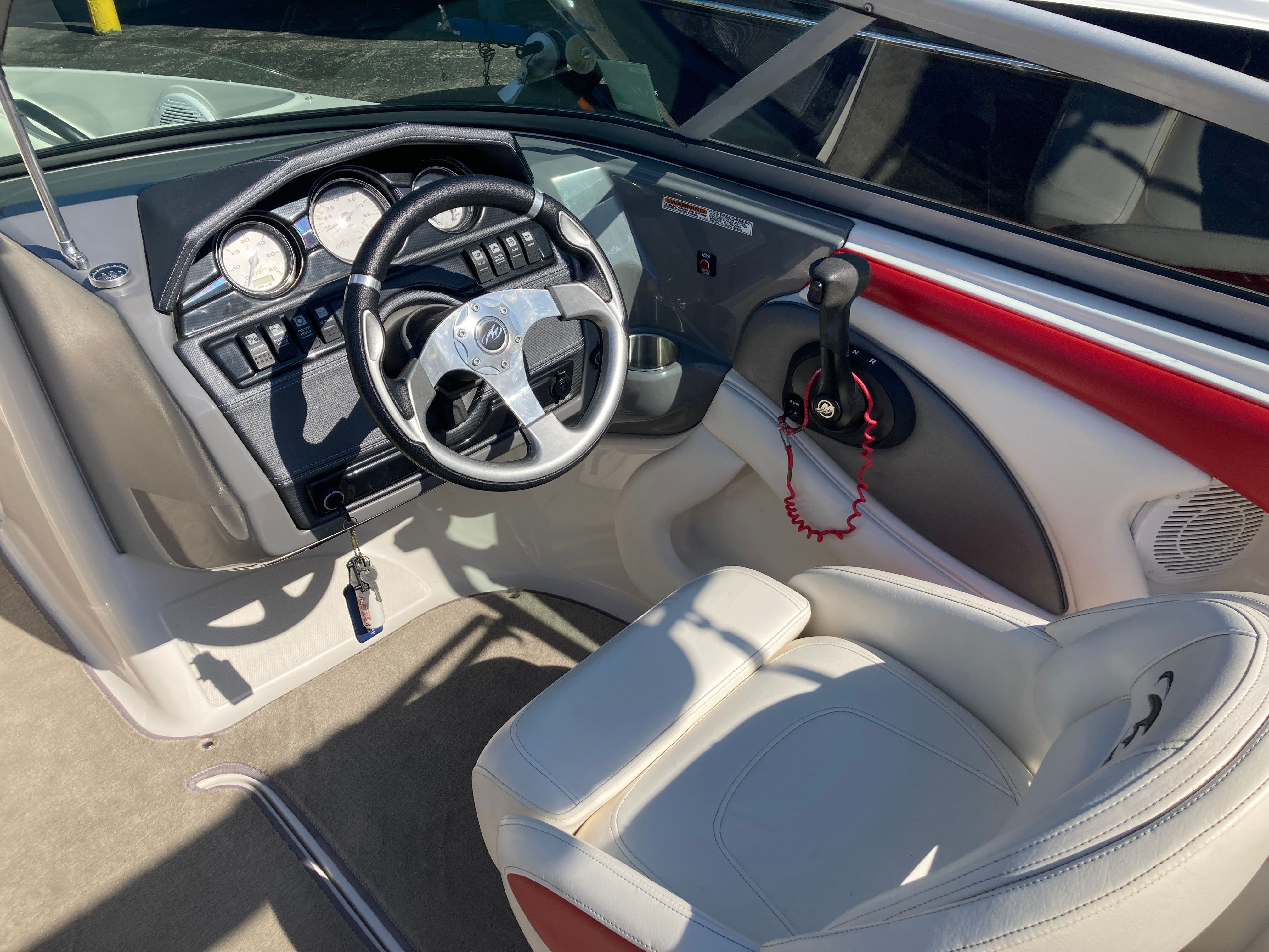 Interior of a 2012 Monterey 204FS boat with steering wheel and dashboard.