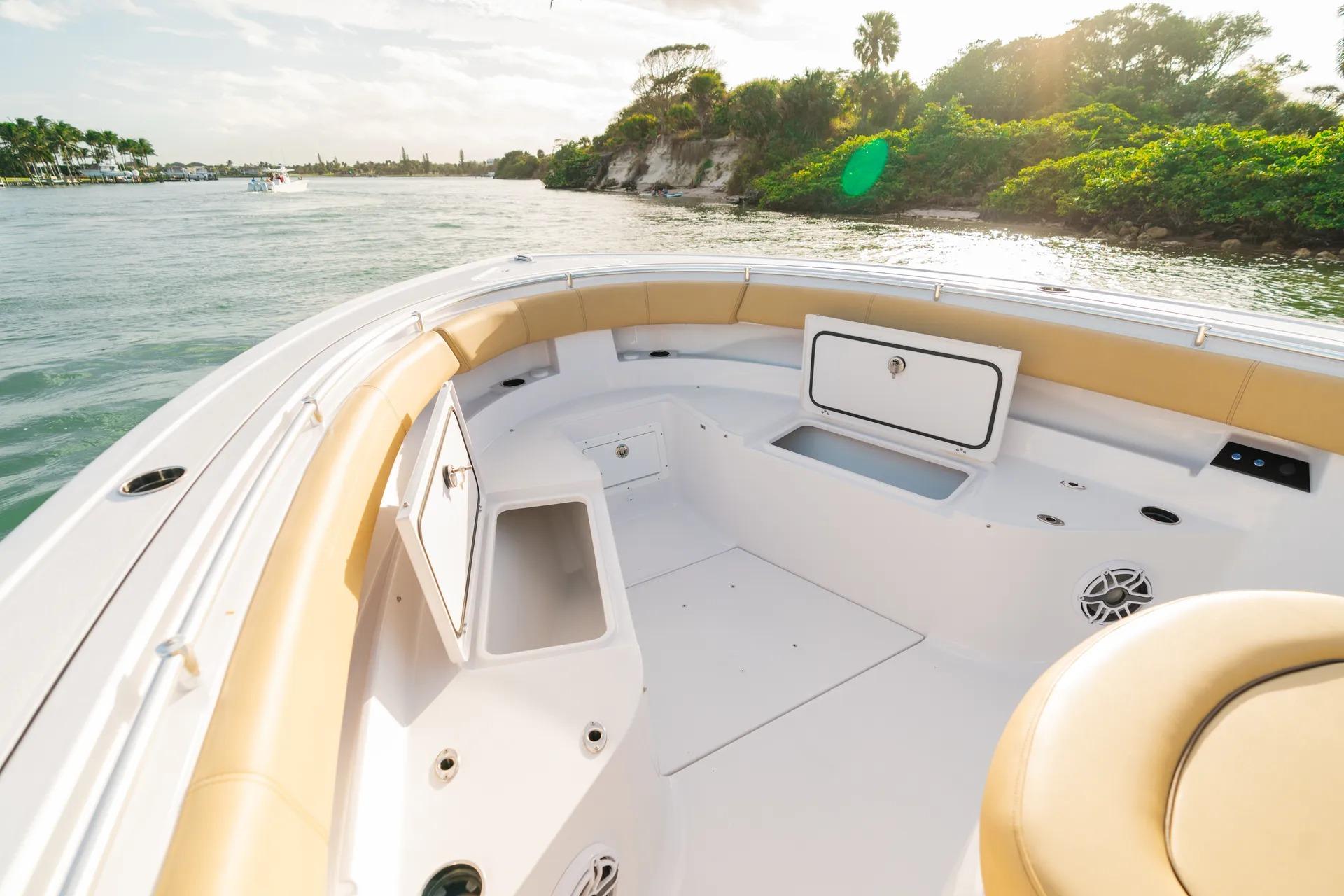 2026 Sportsman Open 352 Center Console boat interior with tan seating, on a scenic waterway.