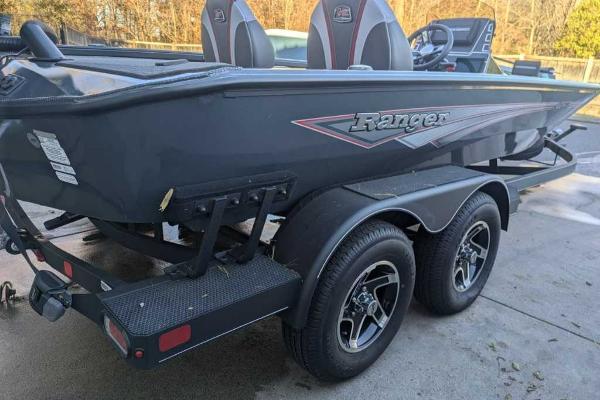 2025 Ranger ALPHA 208 boat on trailer, sleek design, dual axles, outdoor setting.