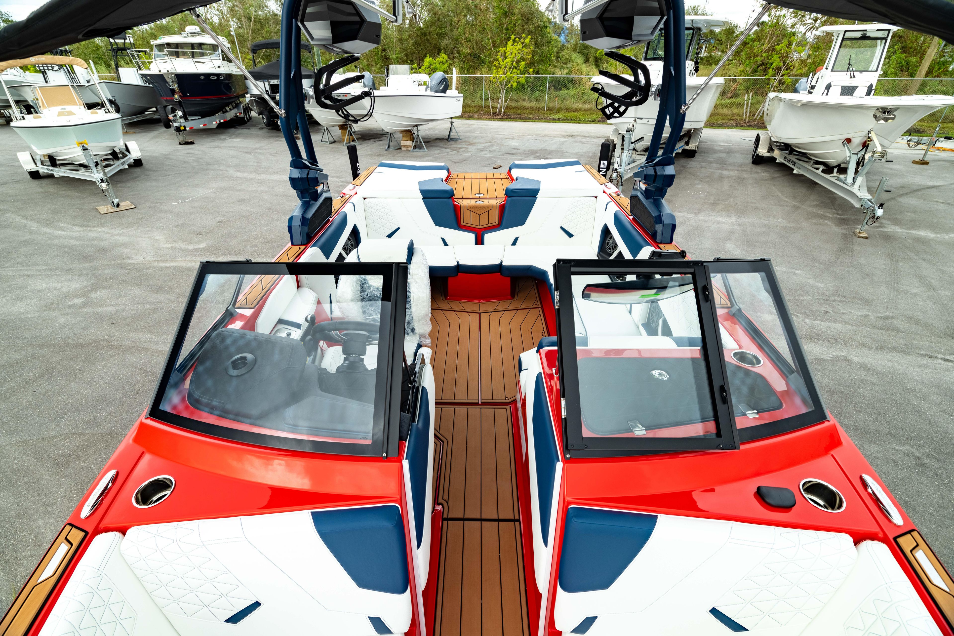2025 Nautique Super Air Nautique GS20 boat with vibrant red and white design, docked outdoors.