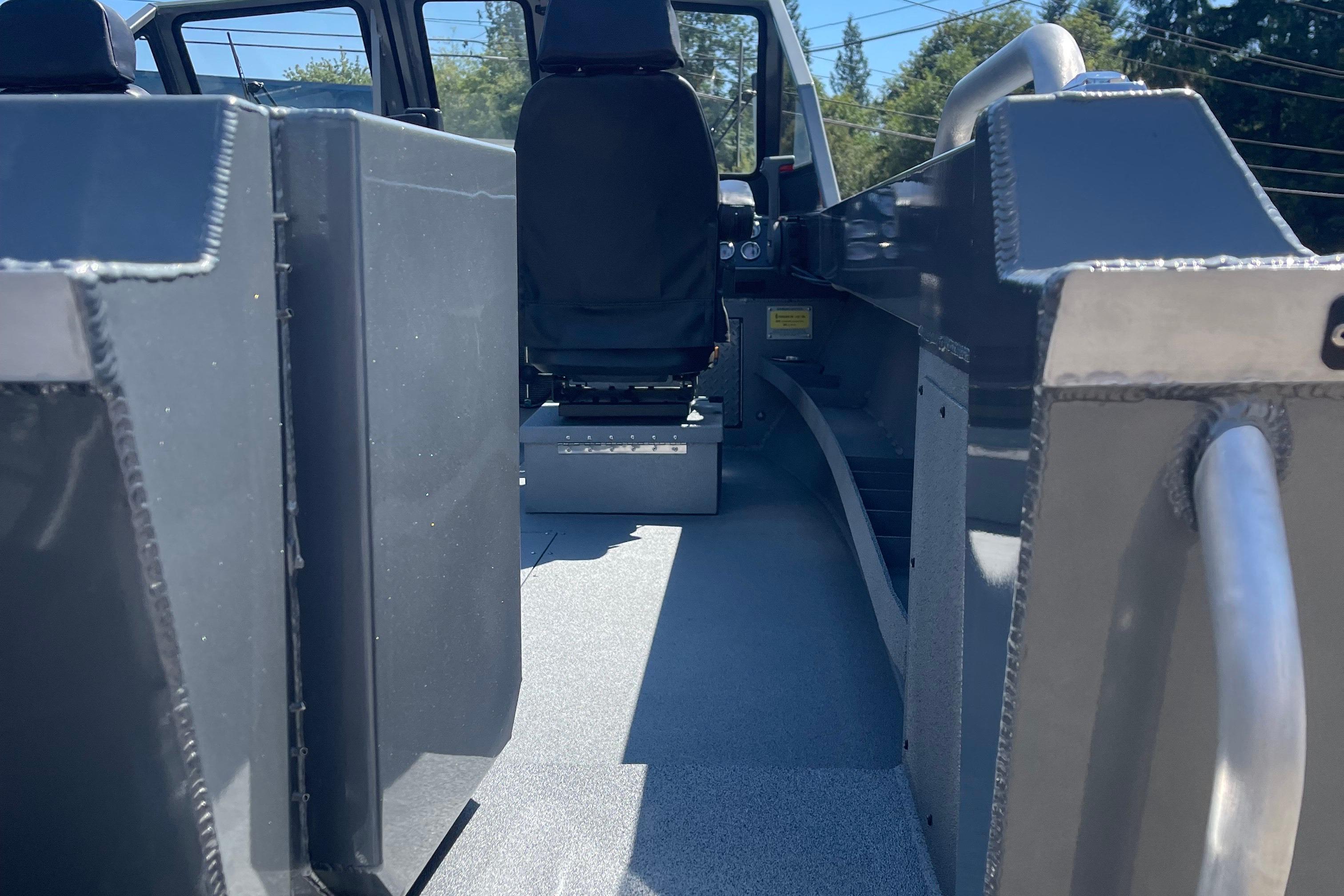 Interior view of 2025 Excel Buoy 10 boat, featuring seating and metal construction.