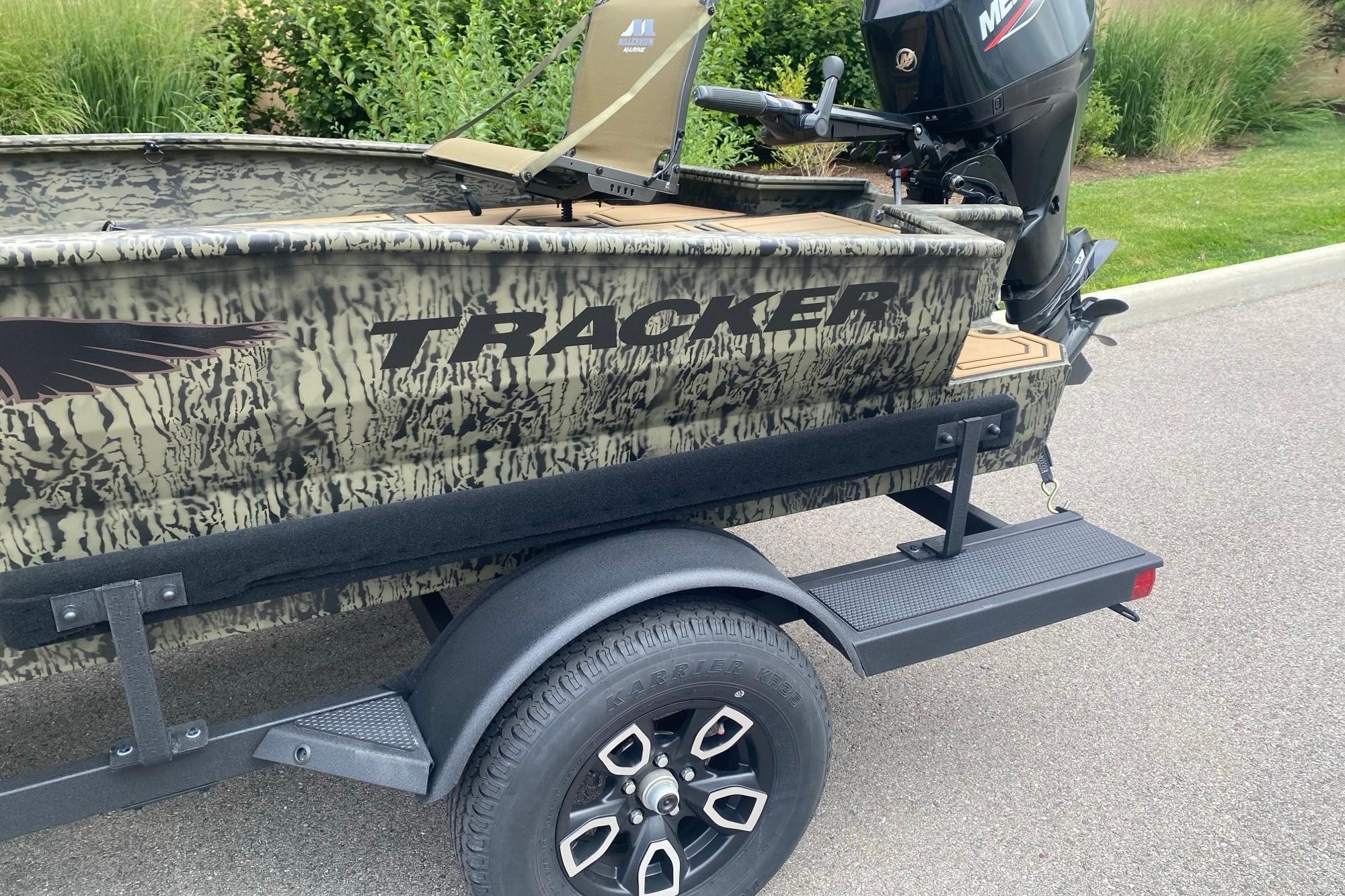 2026 Tracker Grizzly 1650 T Prairie Wings Edition boat on trailer, camo design, Mercury engine.