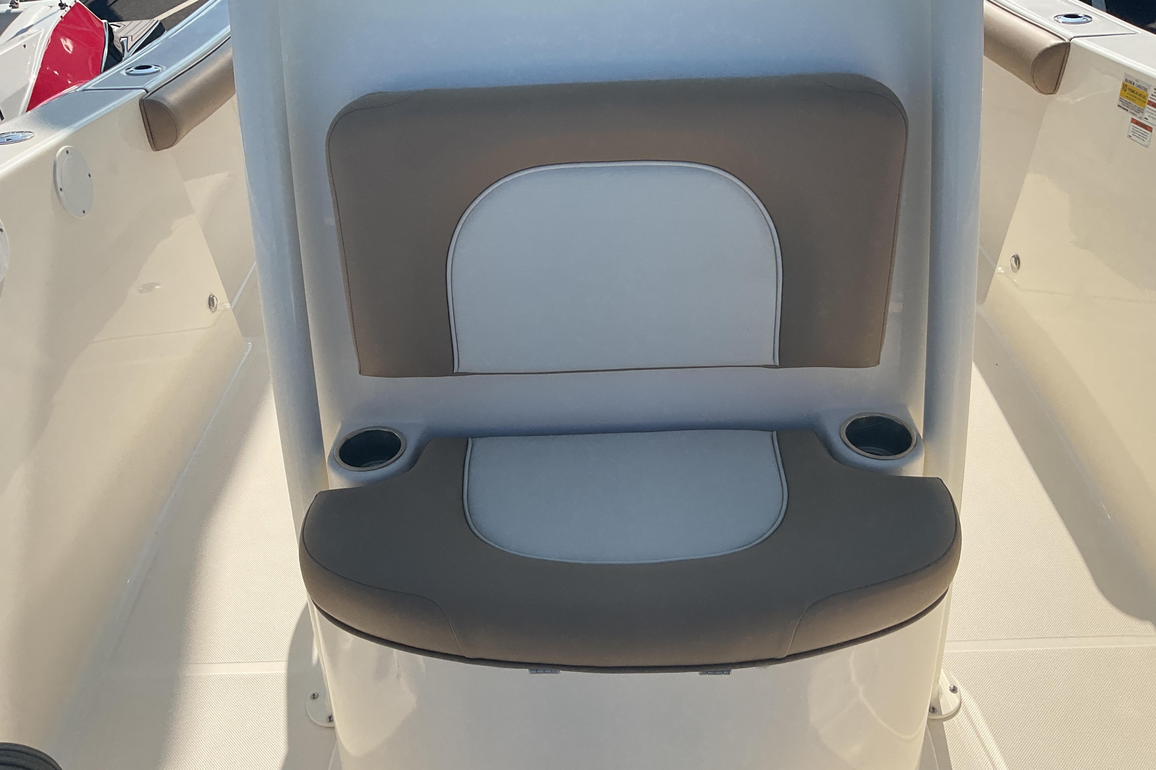 2023 Sea Born SX239 Offshore boat seat with cup holders, beige and white upholstery.