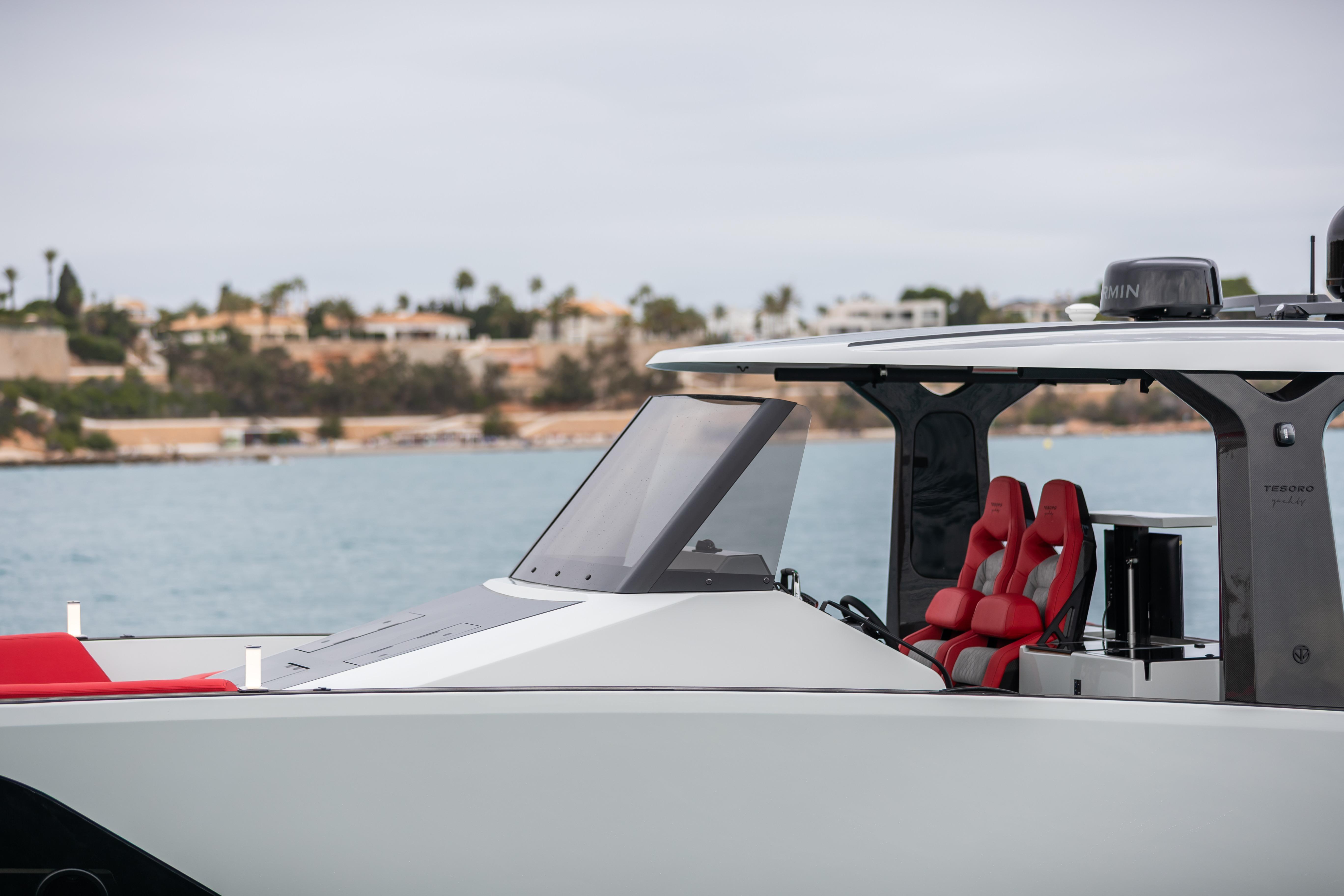 Tesoro 40 GTS 2026 yacht with red interior by the water.