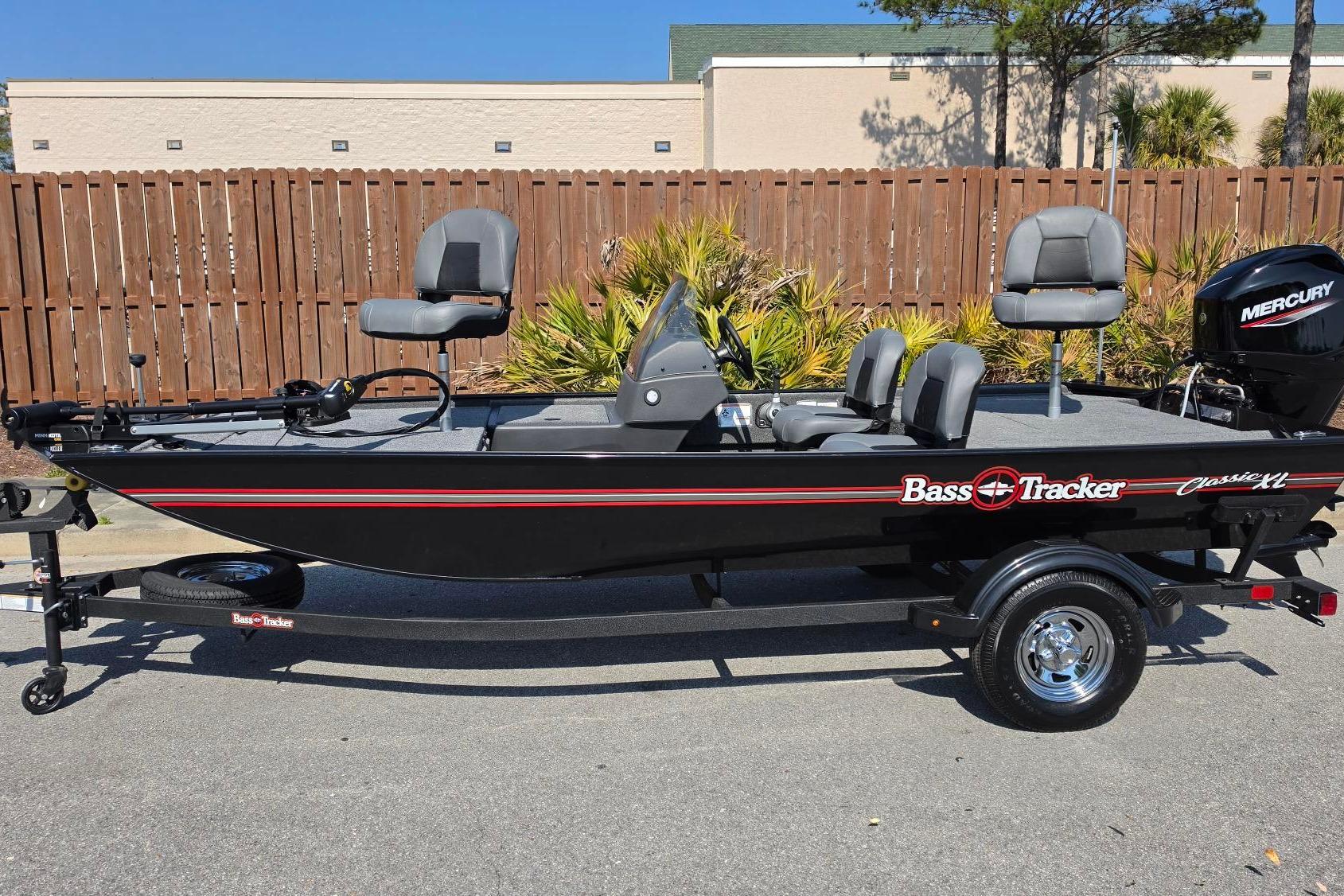 2026 Tracker Bass Tracker Classic XL fishing boat with Mercury engine, parked outdoors.