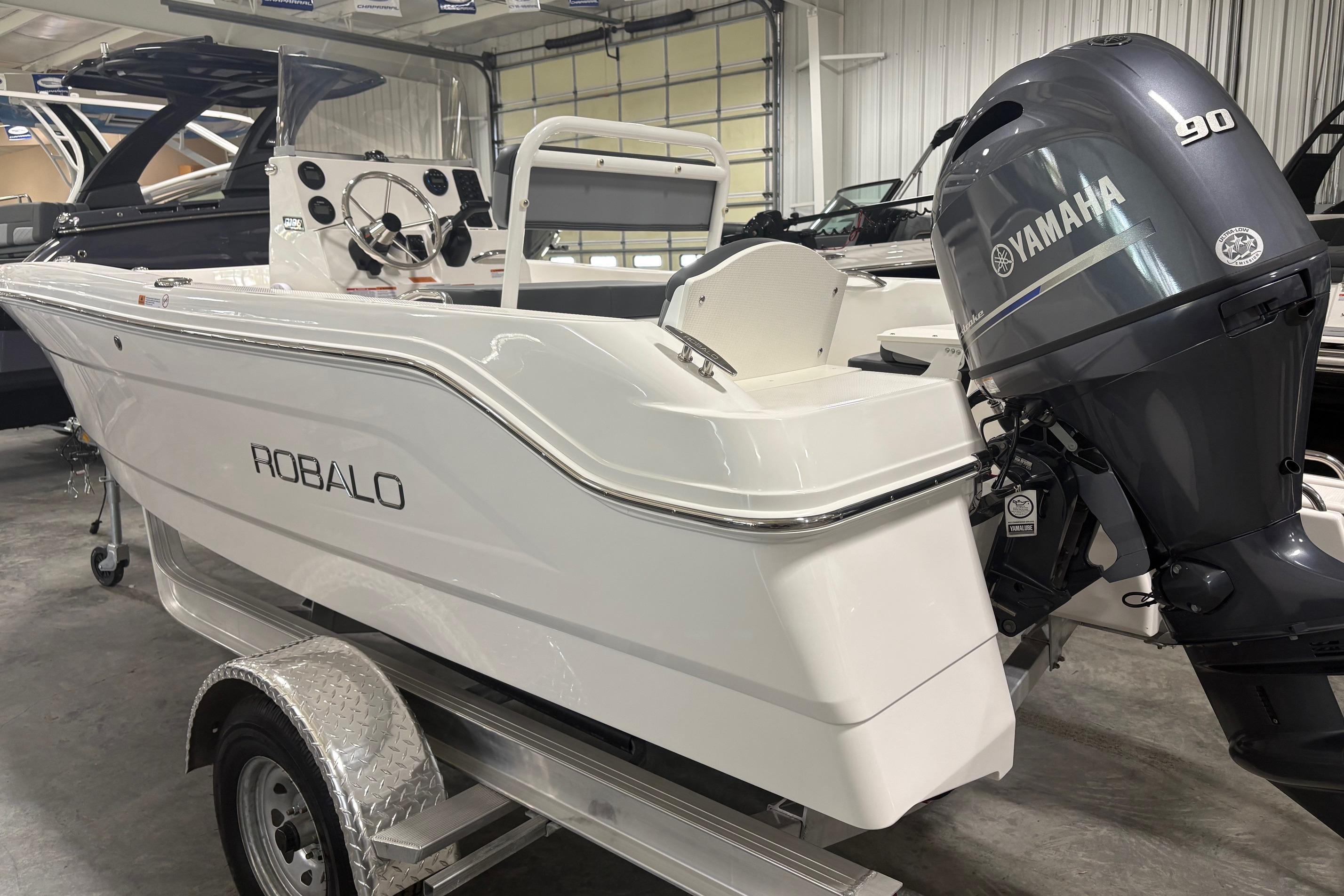 2026 Robalo R160 Center Console boat with Yamaha 90 engine in showroom.