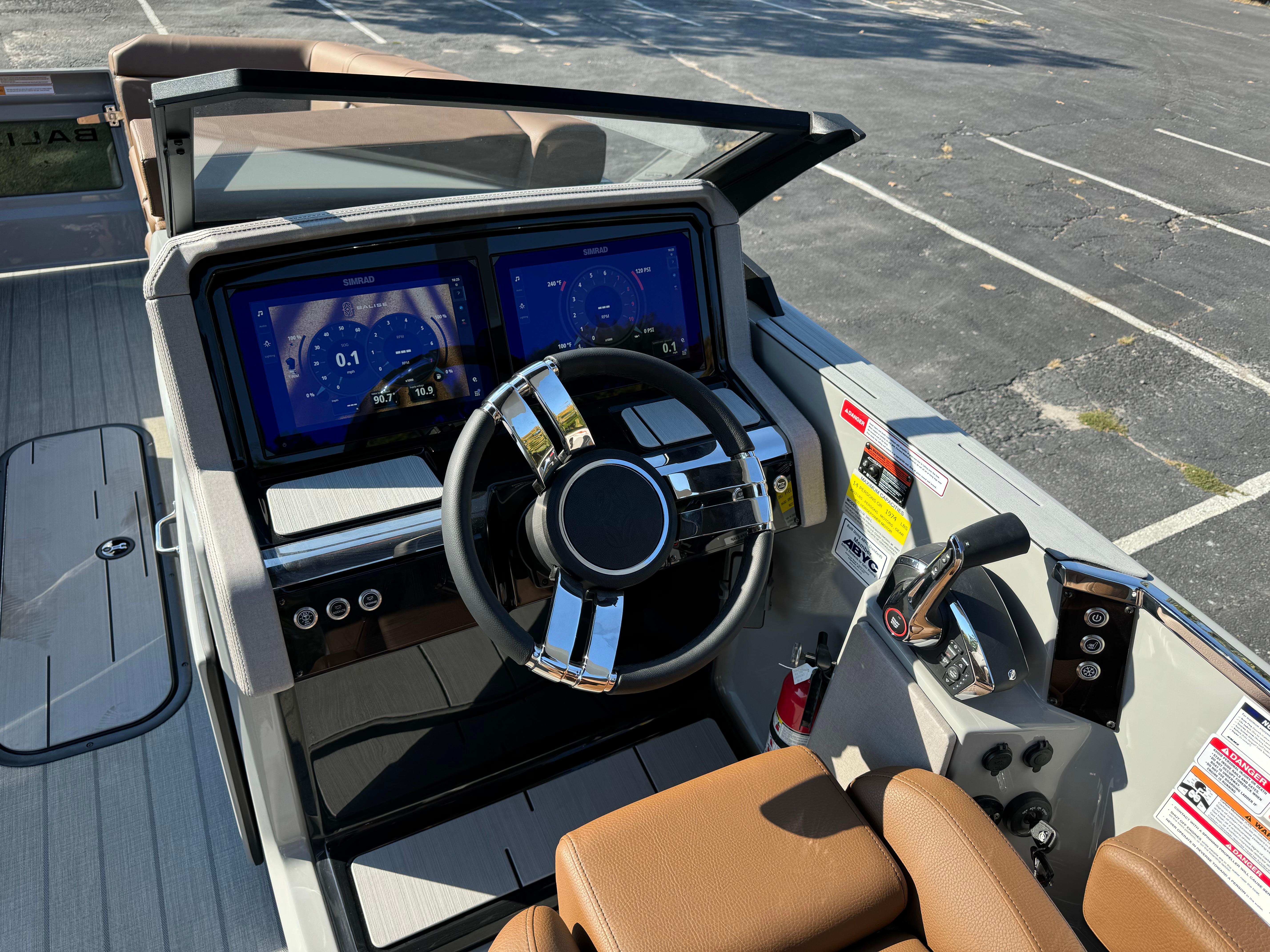Modern boat dashboard with dual screens and leather seats, Balise Helix 24L, 2025 model.