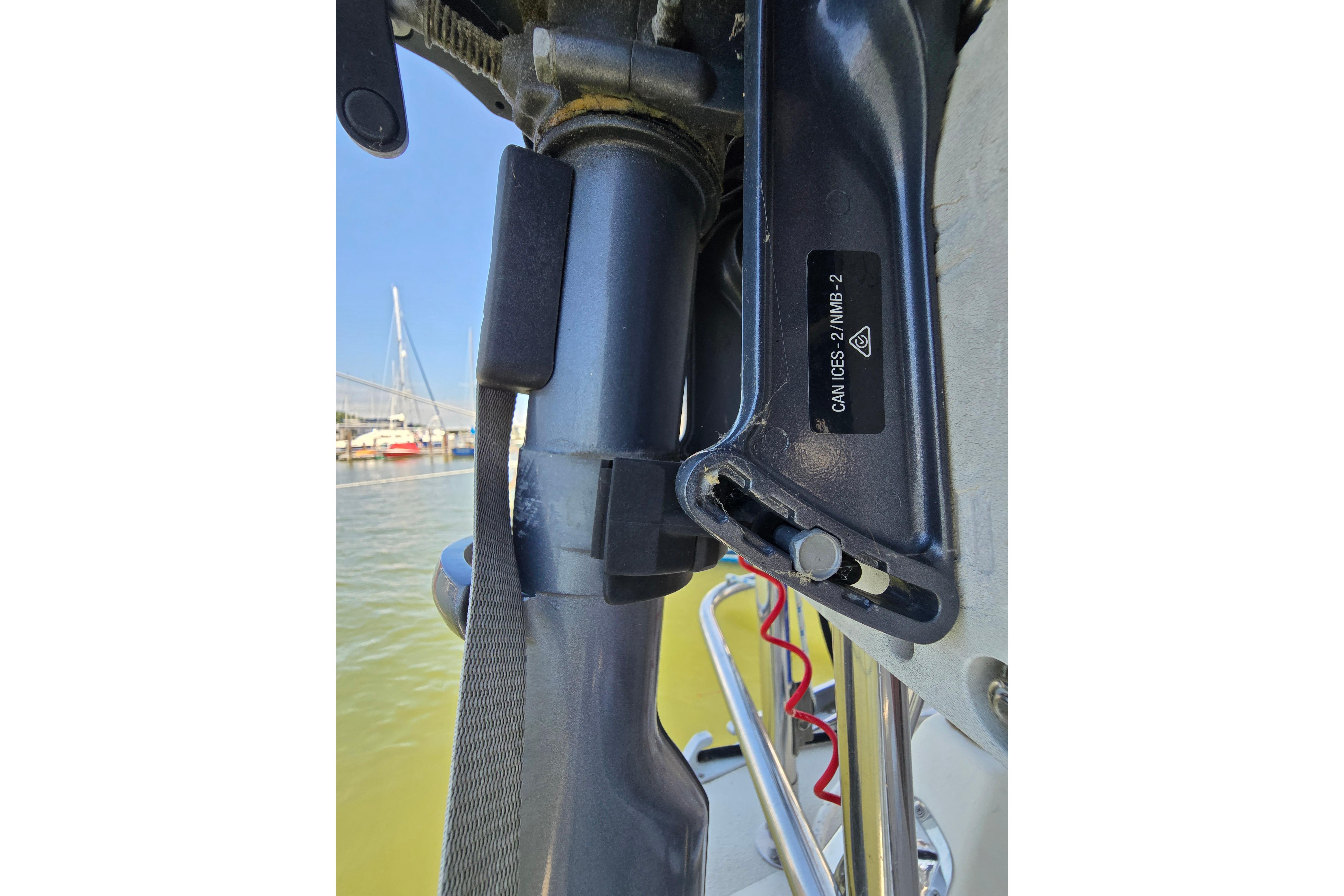 Close-up of a 1993 Caliber 35 boat component with visible label and marina background.