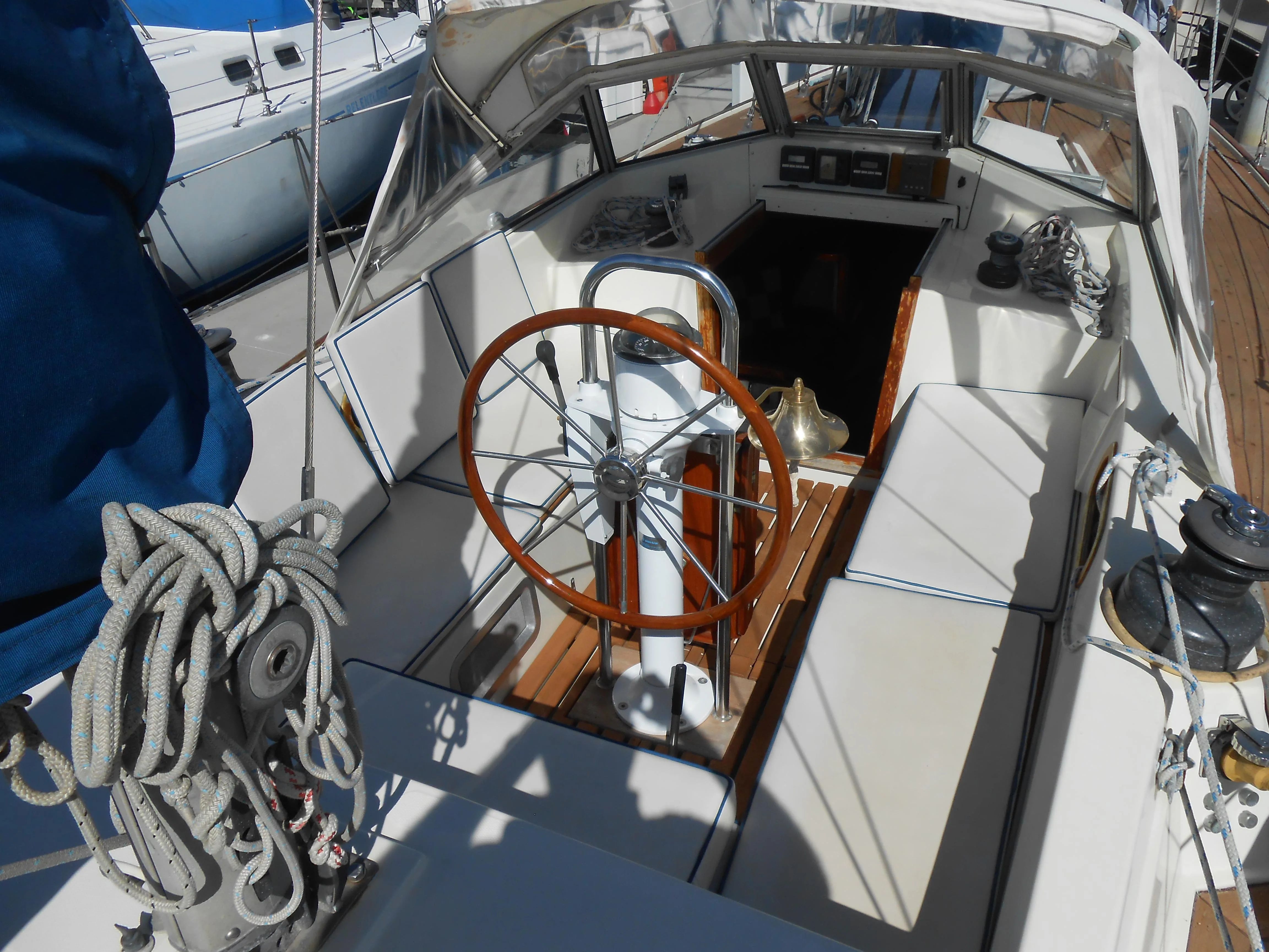 Cockpit of a 1985 Contest 41 Ketch with steering wheel and seating area.