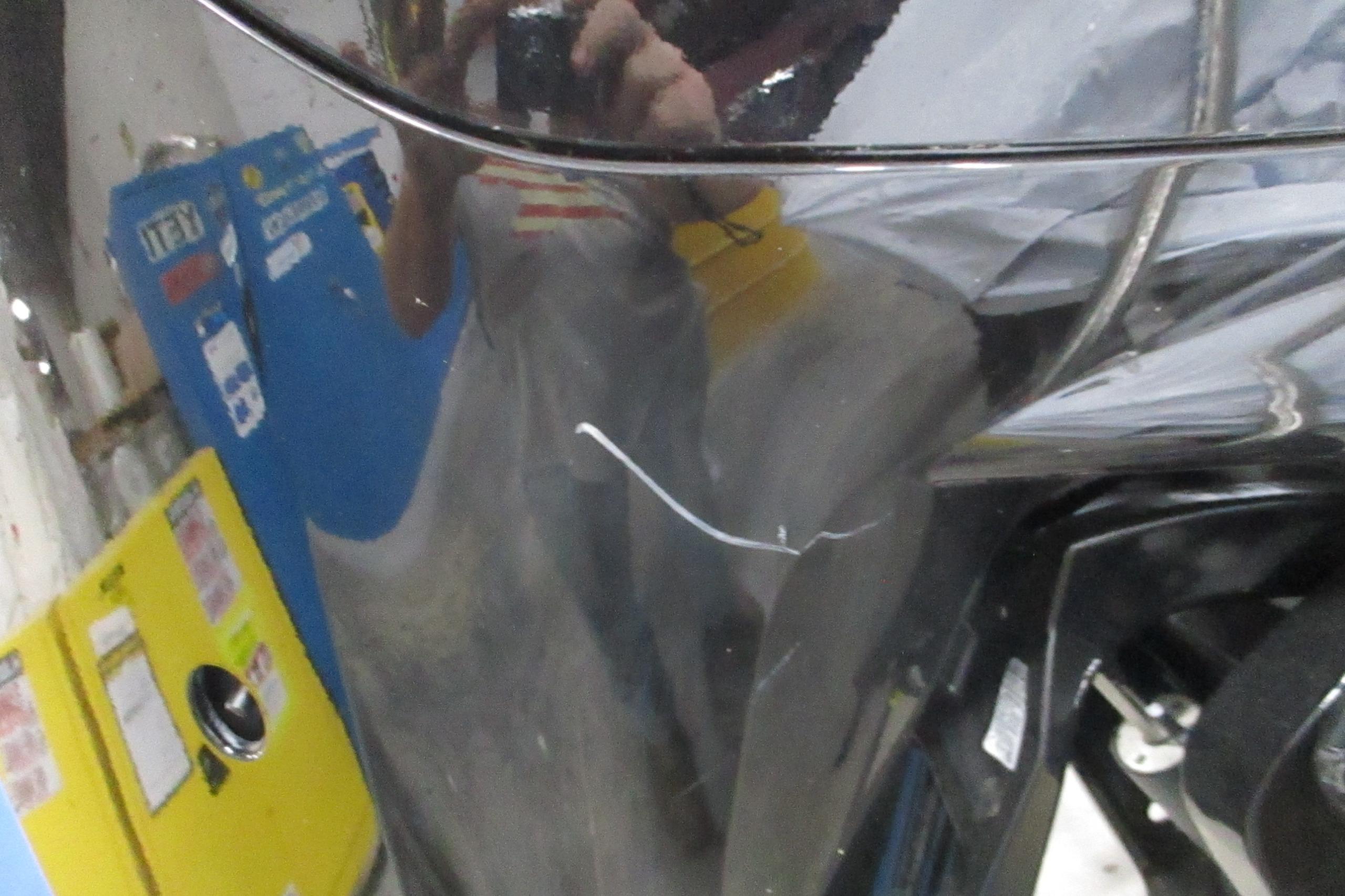 Close-up of a 2025 Tahoe T18 with visible scratch on the black surface.