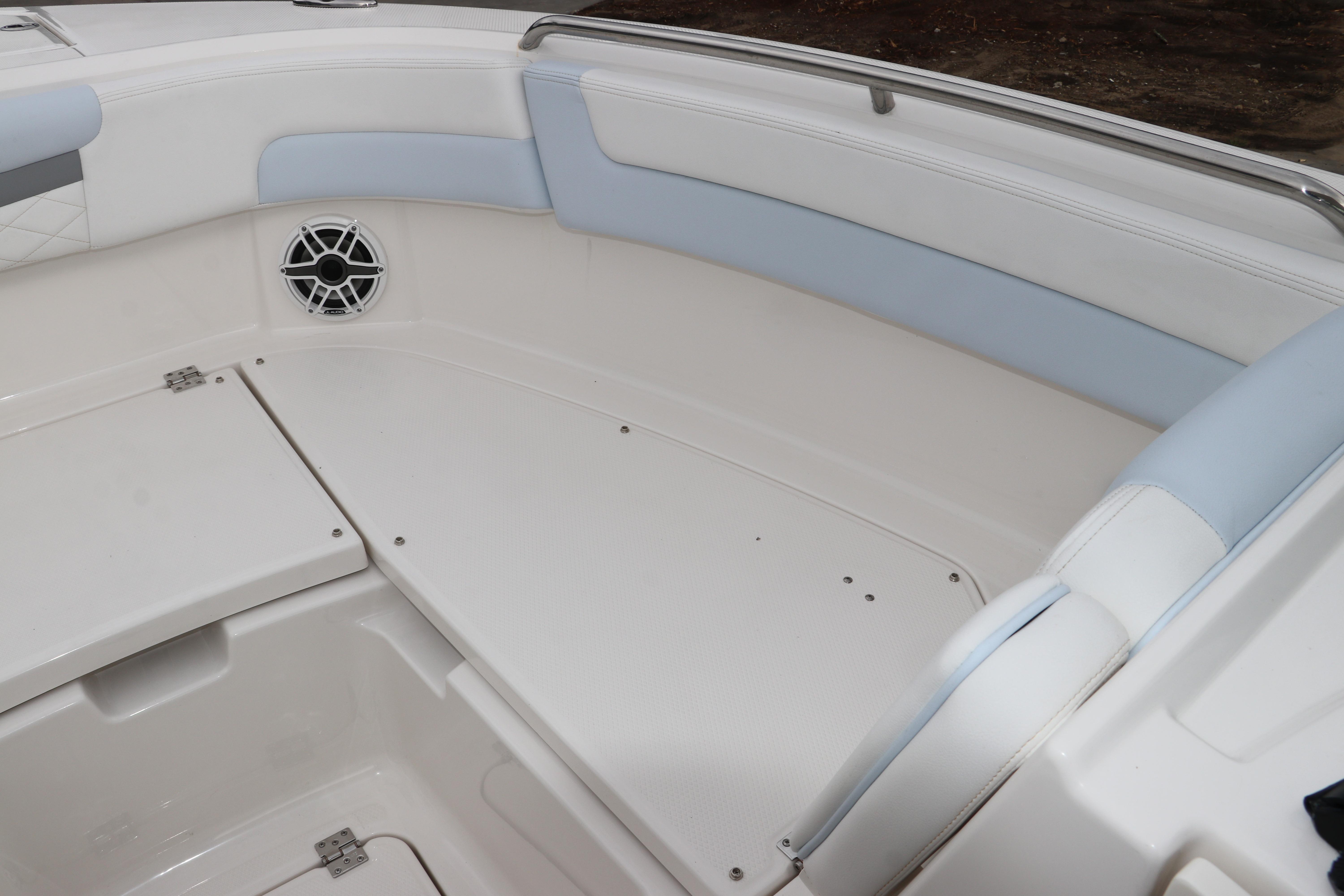 2026 Robalo R257 Dual Console boat interior with cushioned seating and speaker.