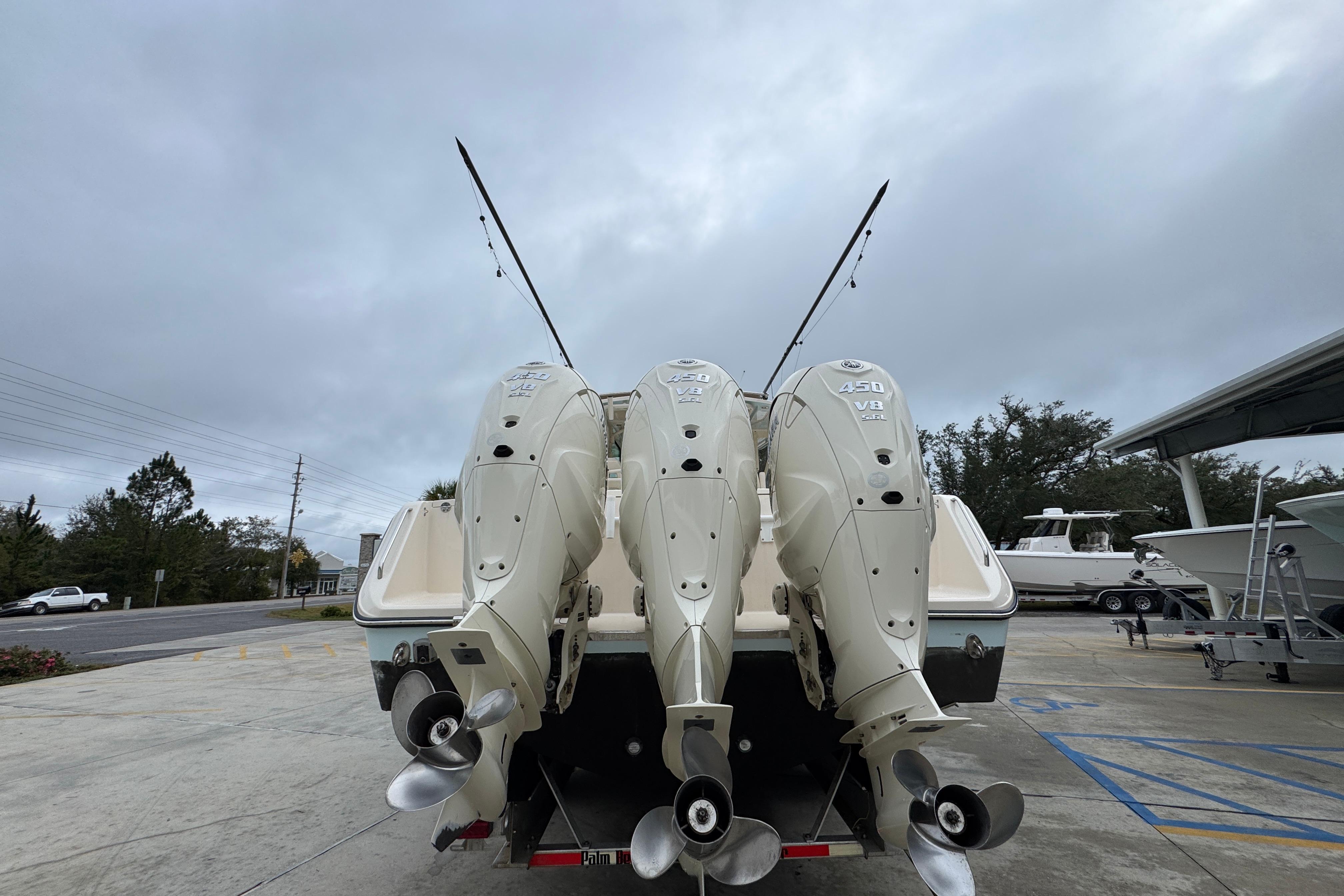 2024 Grady-White Canyon 386 boat with triple 450 V8 engines, docked outdoors.