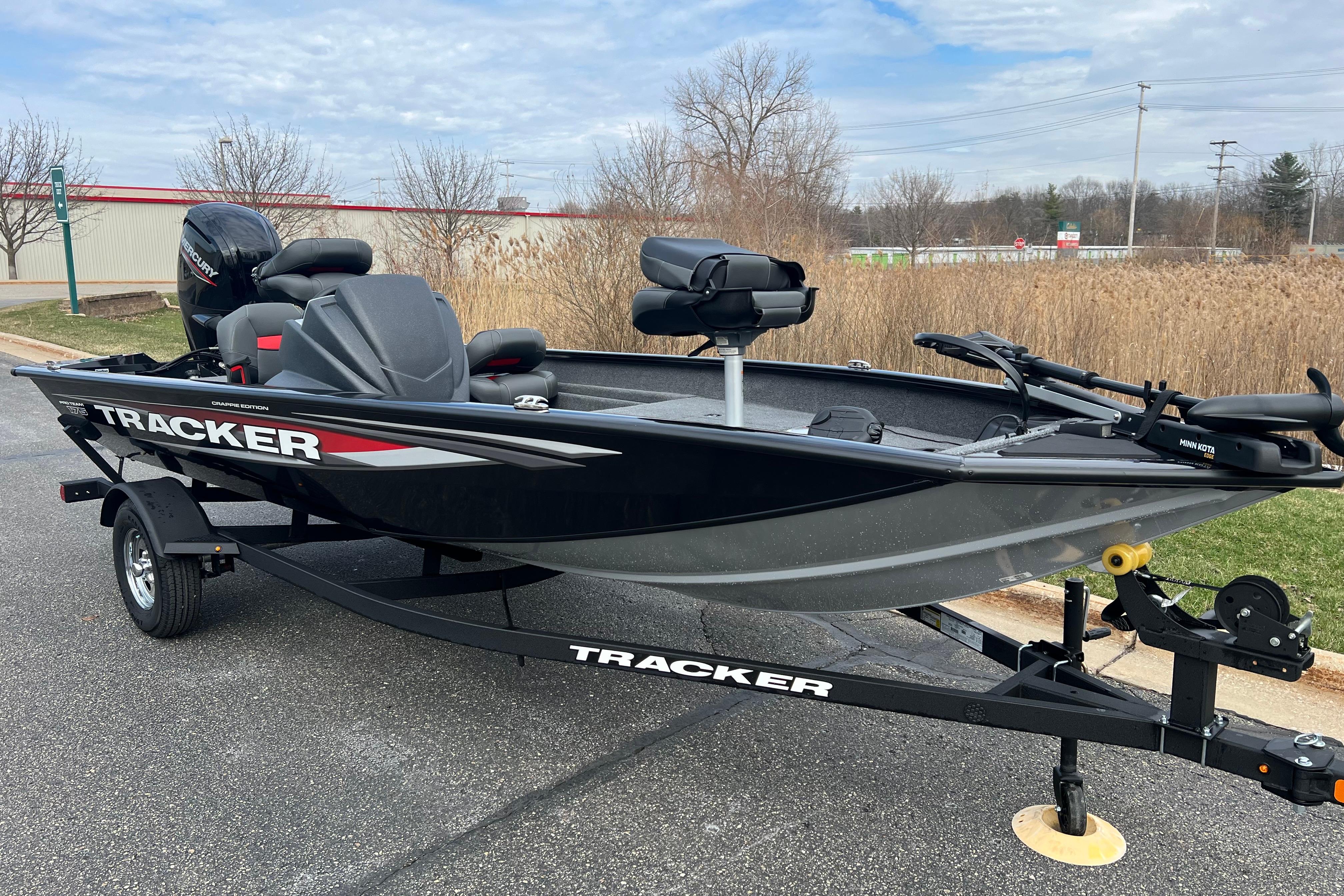 2026 Tracker Pro Team 175 Crappie Edition boat on trailer, parked outdoors.