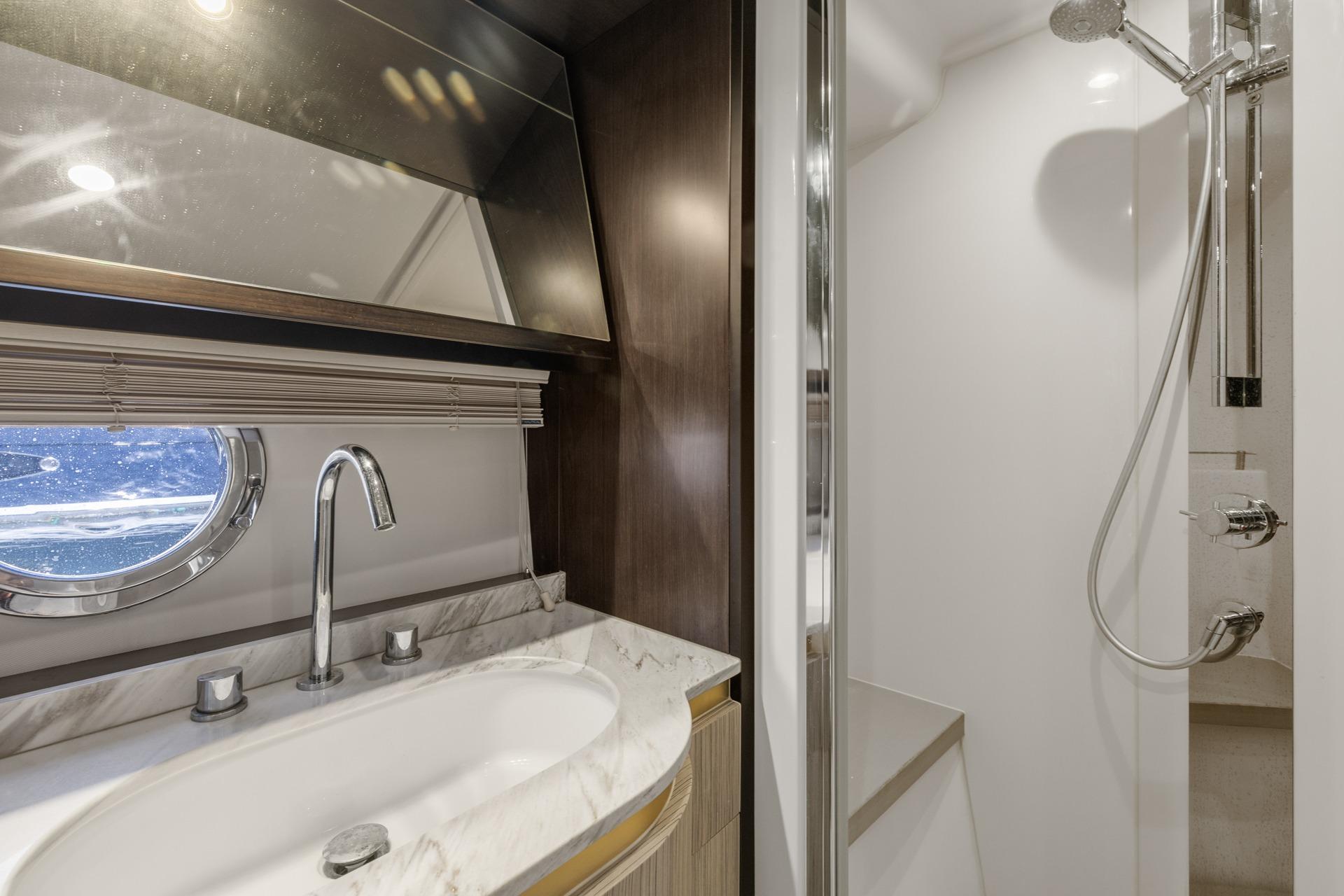 Luxurious bathroom in 2019 Azimut 55 yacht with modern fixtures and shower.