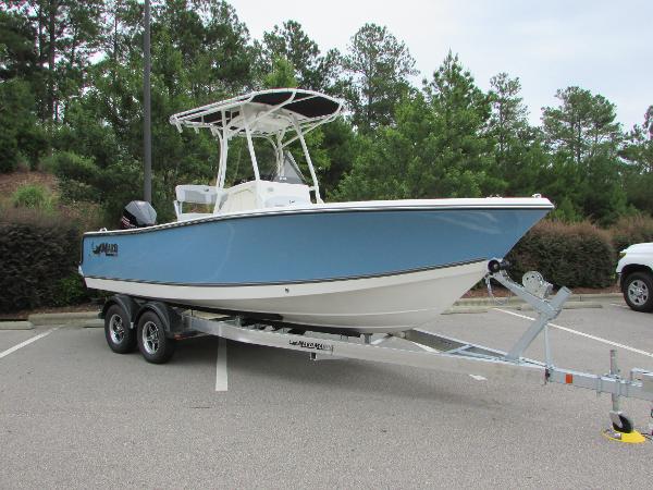 2023 Mako 214 CC boat on a trailer in a parking lot.
