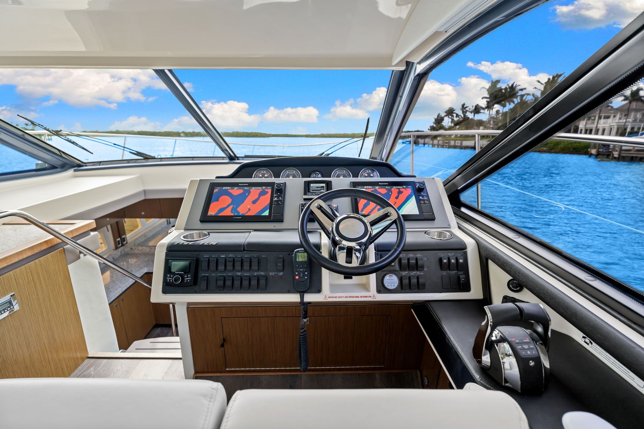 The cockpit of a 2017 Sea Ray Sundancer 510 with modern steering and electronics.