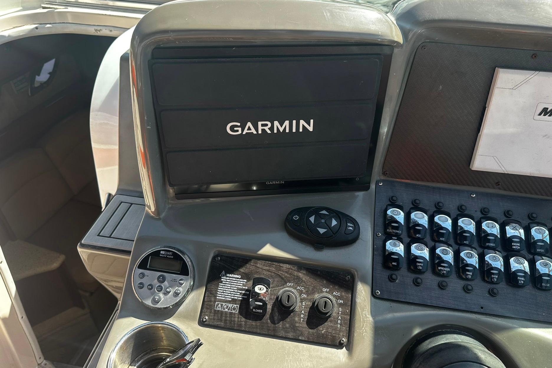 Control panel of a 2012 Rinker 310 Express Cruiser LE with Garmin display.