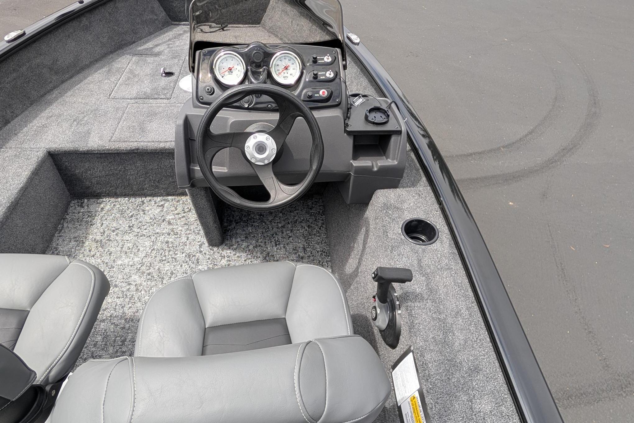 2026 Tracker Super Guide V-16 SC boat interior with steering wheel and dashboard controls.