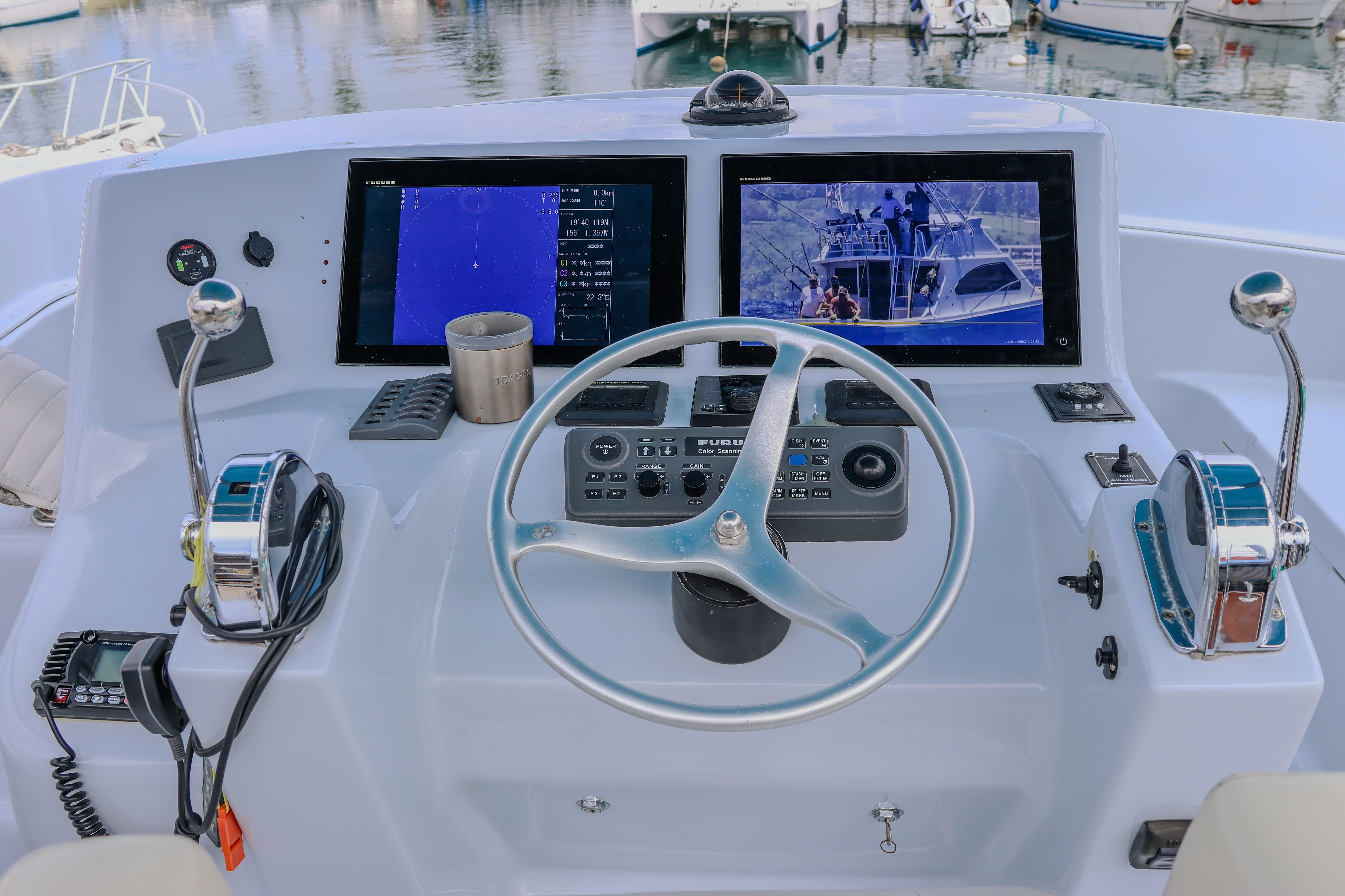 Helm of 2001 Black Watch 40 boat with dual screens and controls.