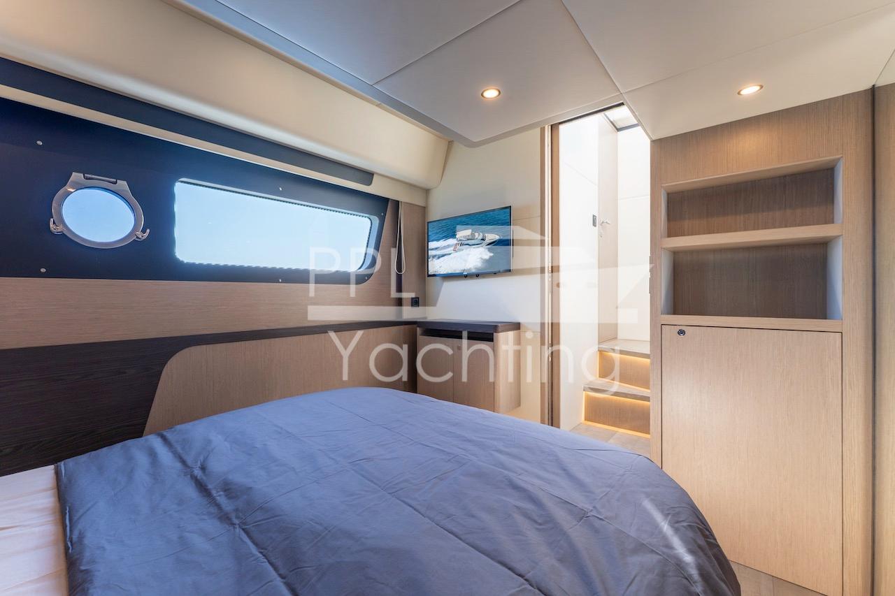 Luxurious cabin interior of 2021 Absolute 47 Fly yacht with modern design and natural lighting.