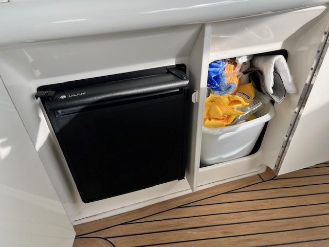 Mini fridge and storage compartment on 2005 Sea Ray 500 Sundancer yacht.